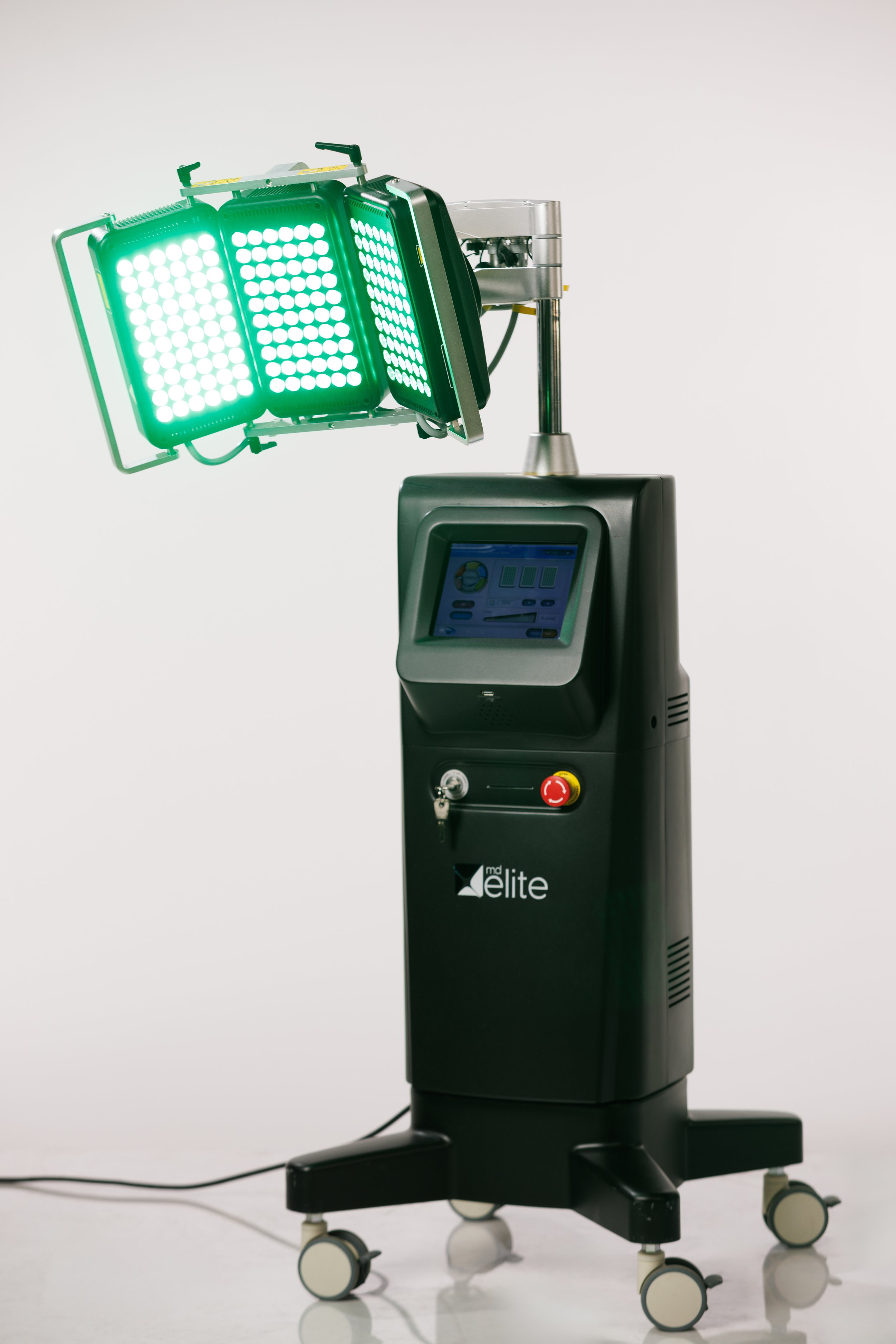 Medical laser device with multiple green laser panels and a display screen labeled 'InfinityPro by MD Elite'.