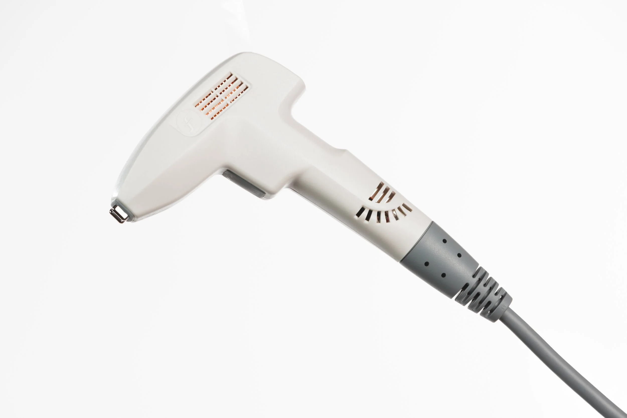 A person's hand holding a white Fuzzy Logic laser hair removal device with a vent and a logo.