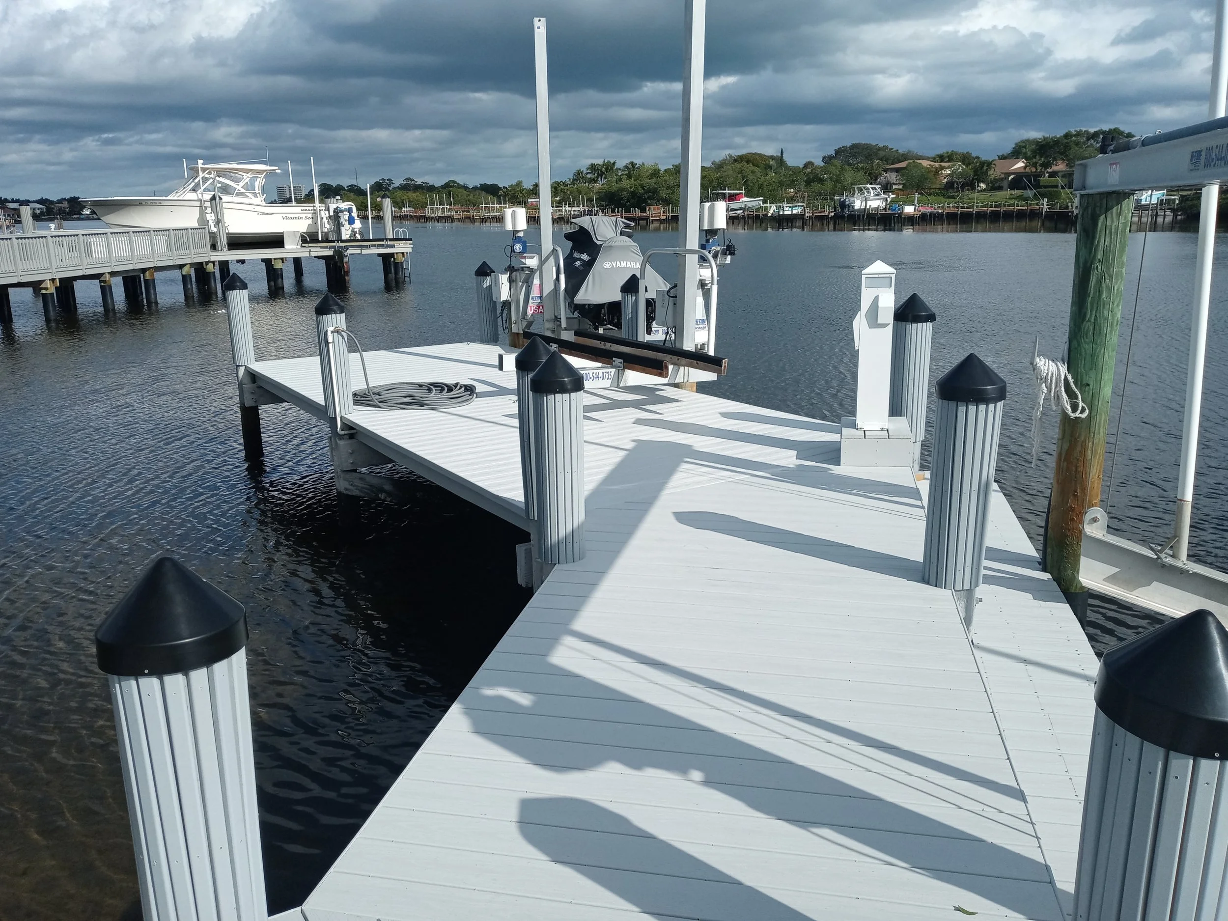 Dock with slatted pilings and jet ski lift