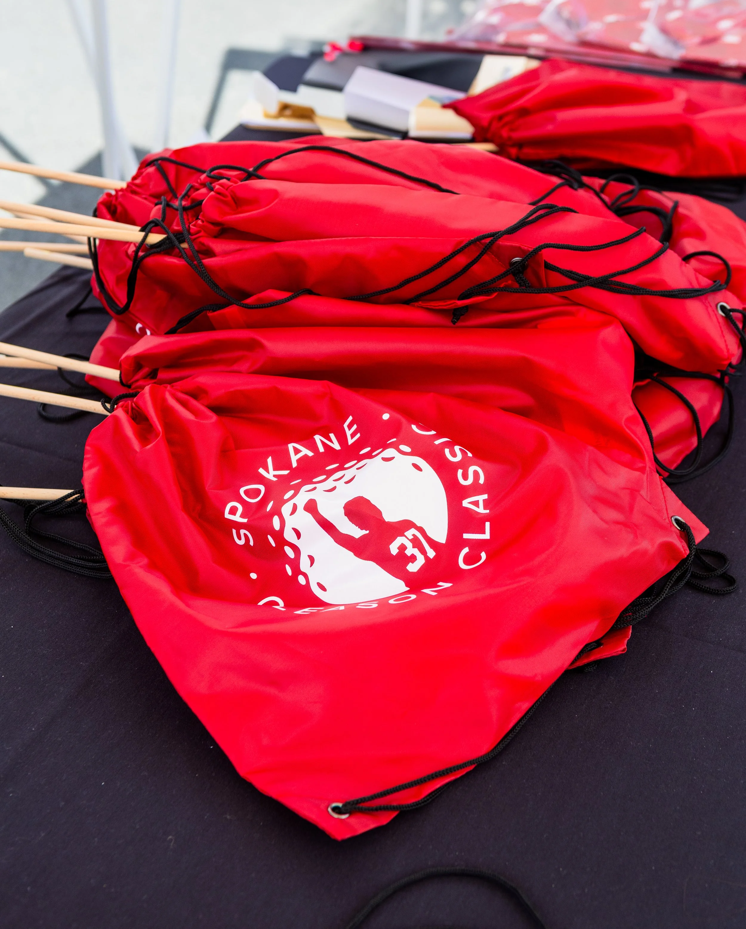Red cinch bags with the Gleason Classic logo