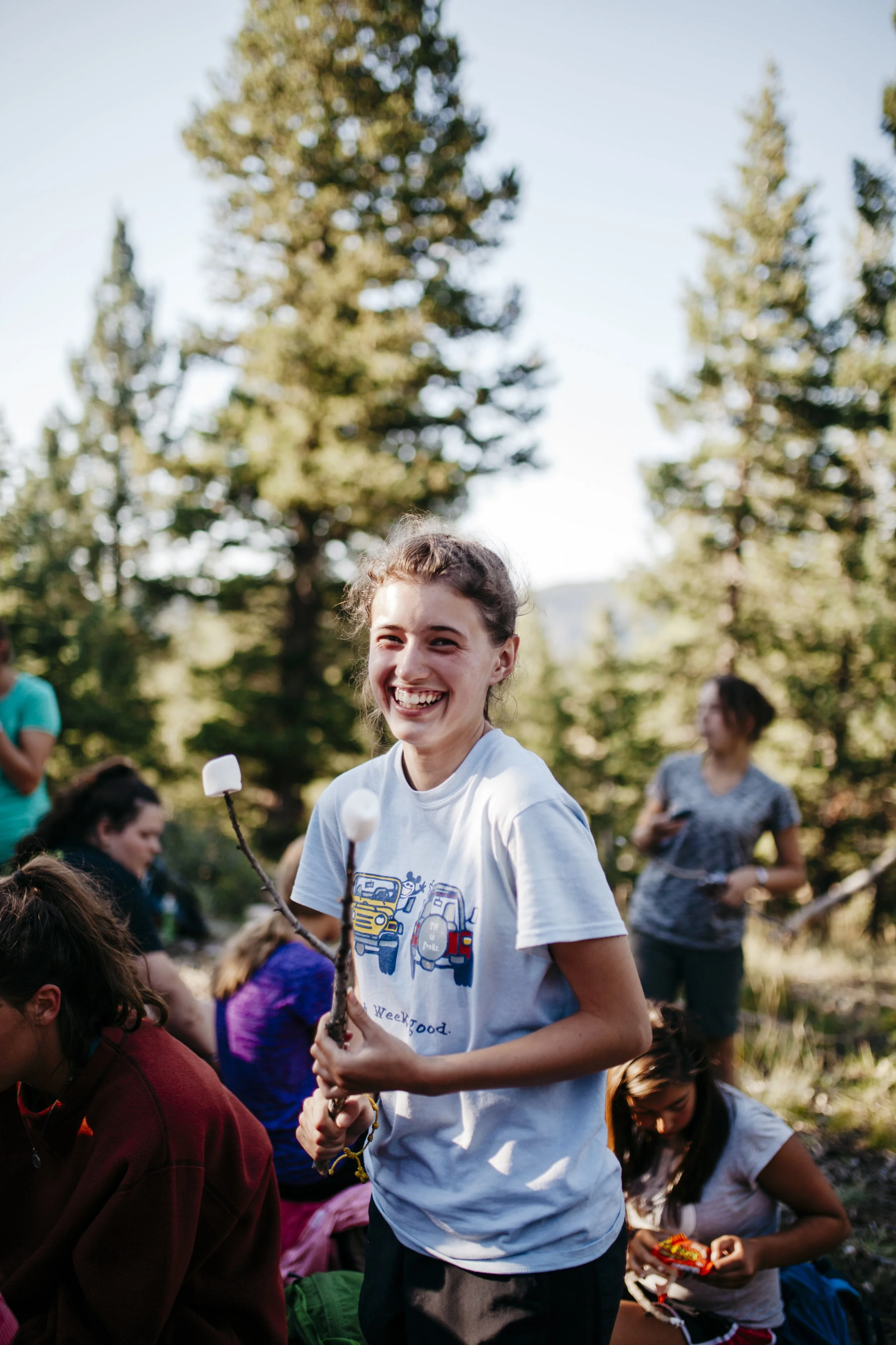 high school girl making a s'more while at a catholic summer camp in Colorado