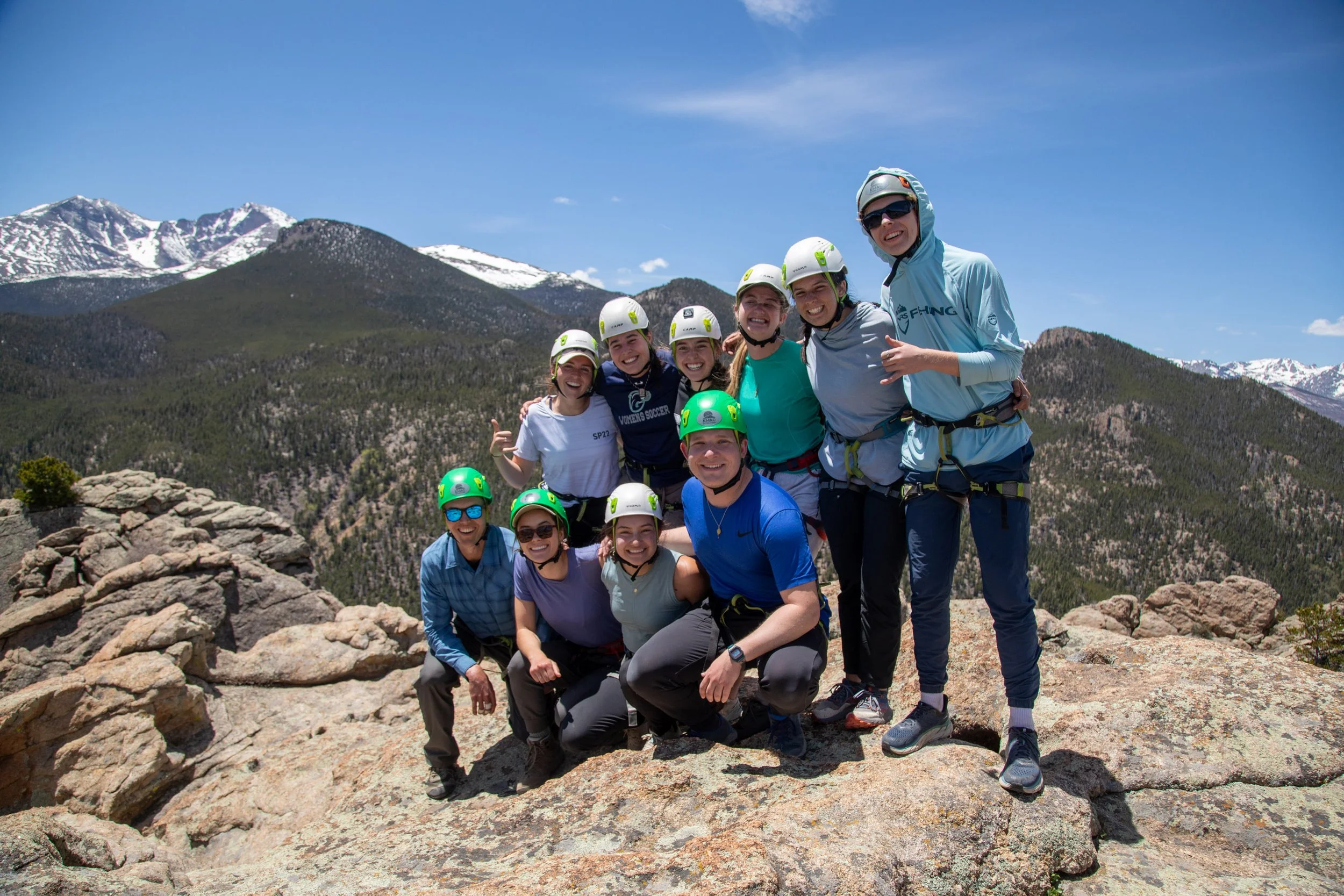 college students rock climbing in Rocky Mountain national park with view of longs peak