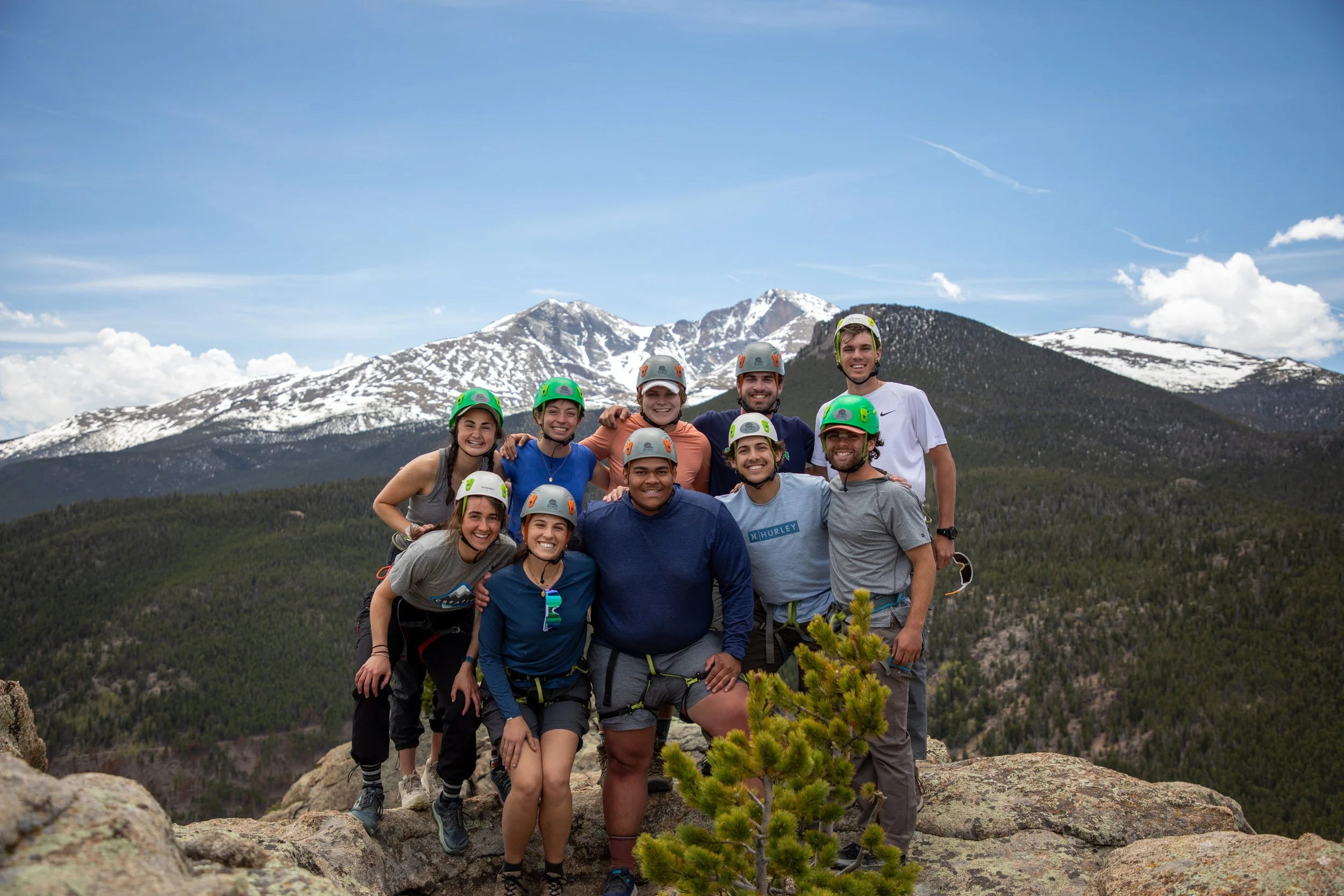 college students rock climbing in the Colorado rocky mountains as camp counselors for a Catholic summer camp