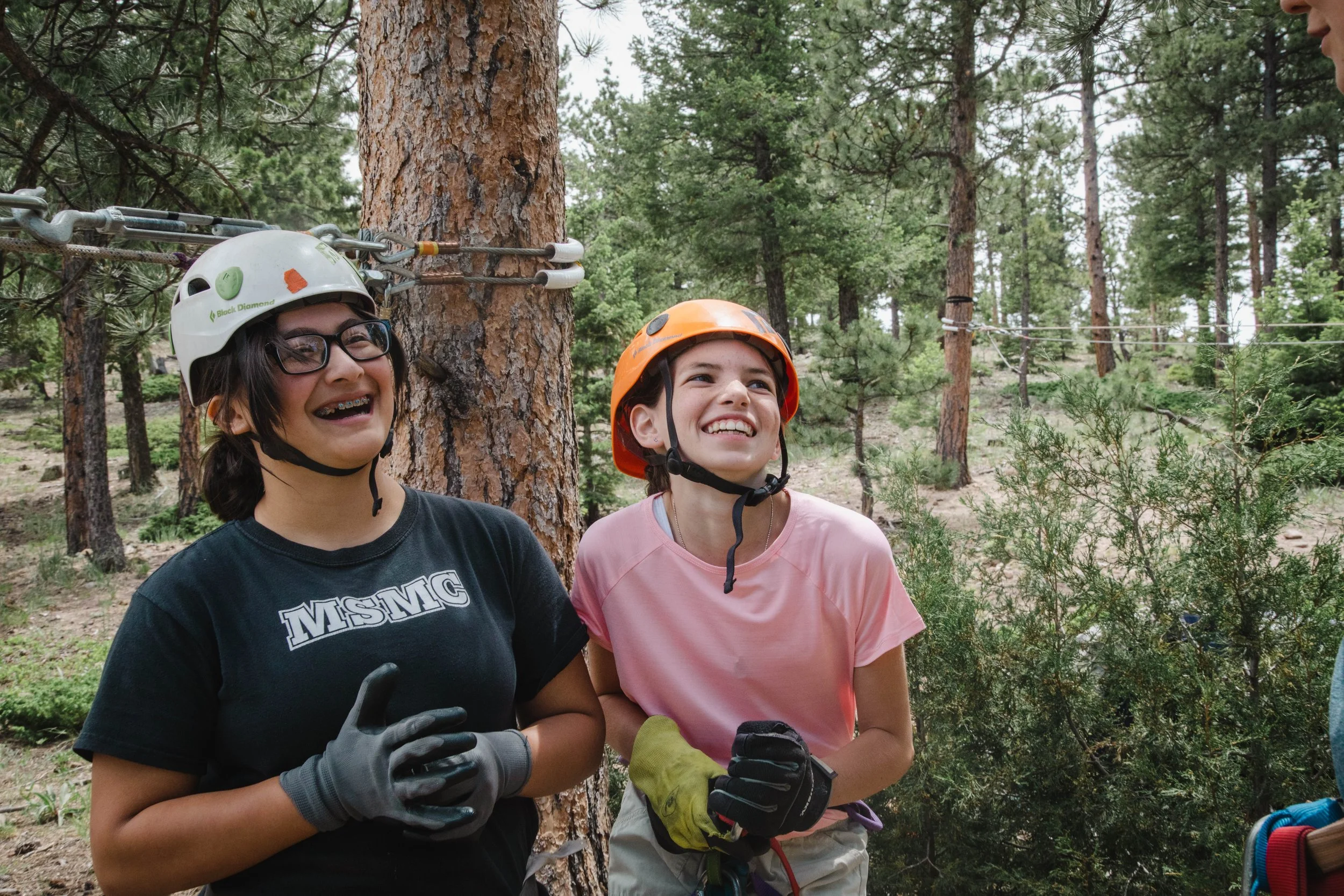 middle school girl campers wearing harnesses at summer camp