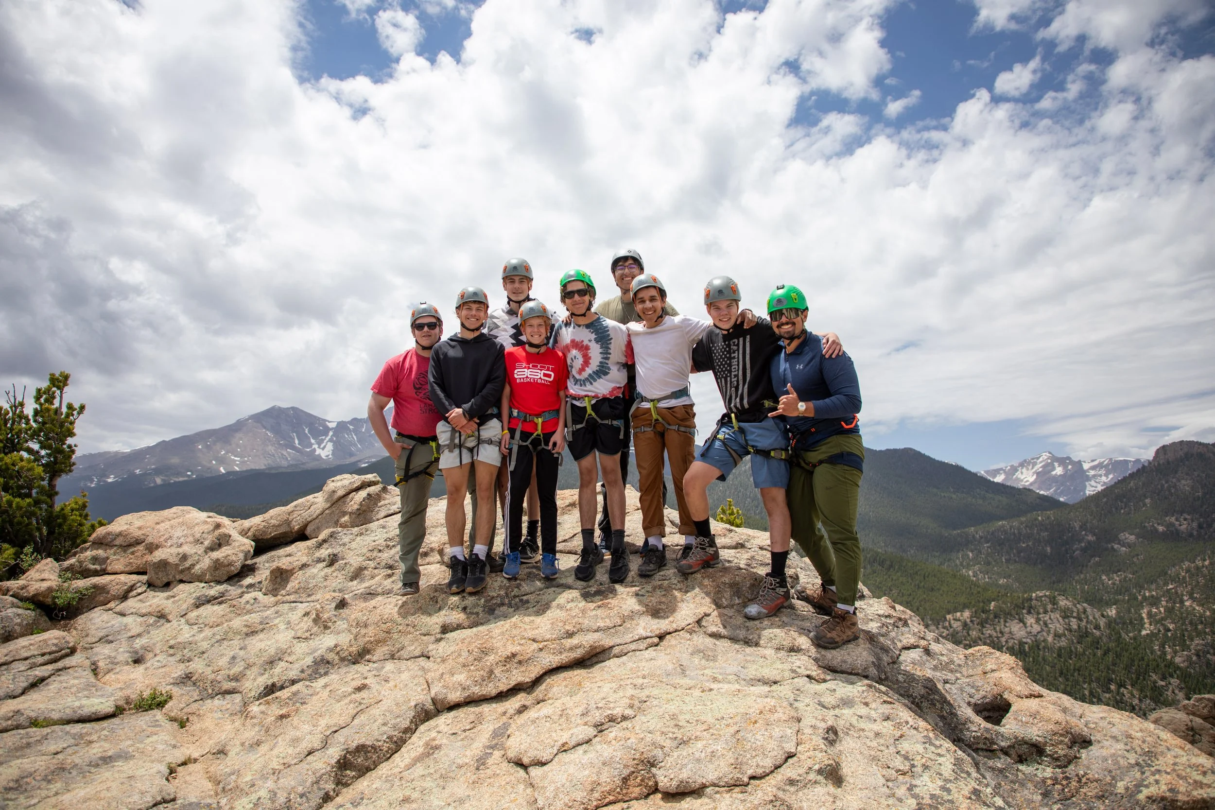 High school guys rock climbing in the Rocky Mountains of Colorado