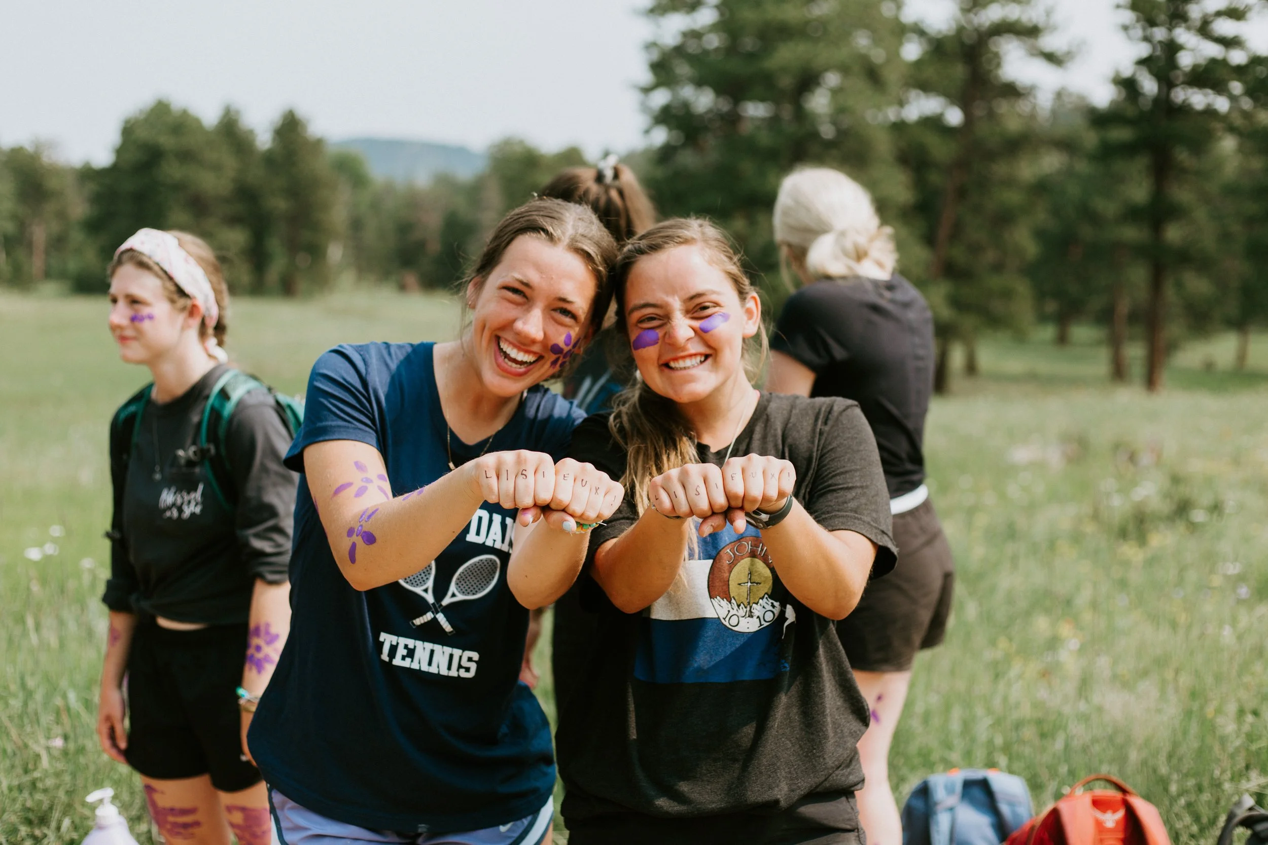 High school girl and her counselor wearing paint at a Catholic summer camp