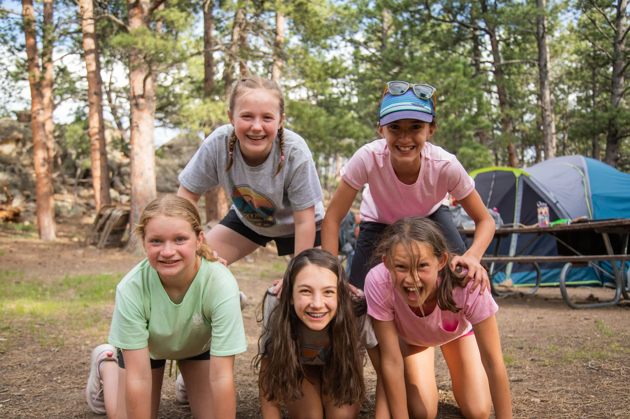 middle school girls making a pyramid at catholic summer camp in colorado