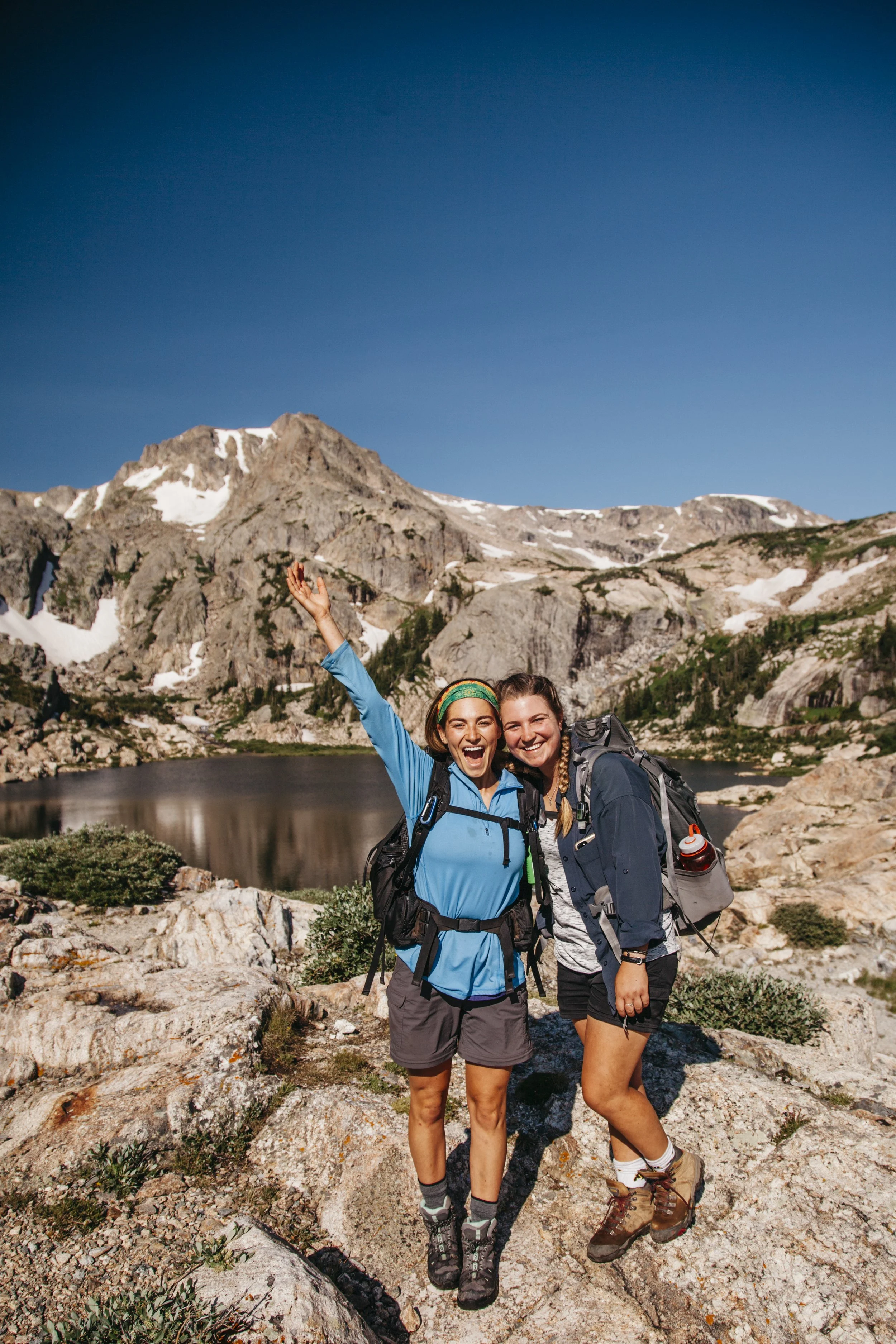 college girls hiking in the Colorado Rocky Mountains while camp counselors at a Catholic summer camp