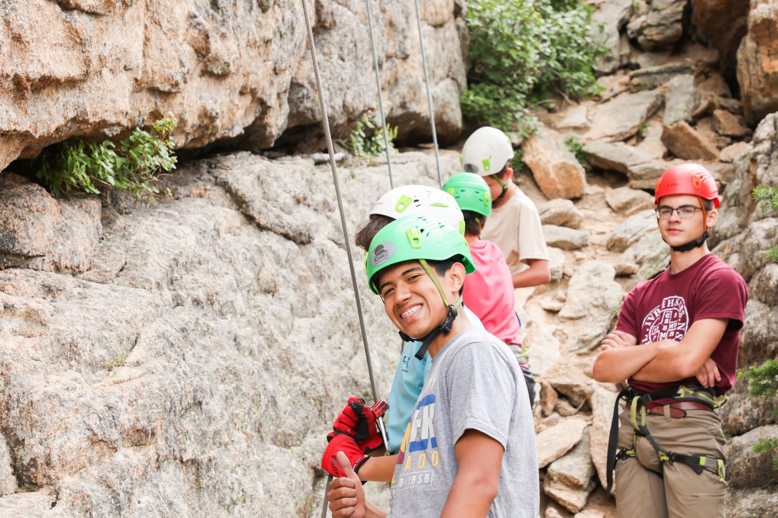 High school guy rock climbing in the Rocky Mountains of Colorado