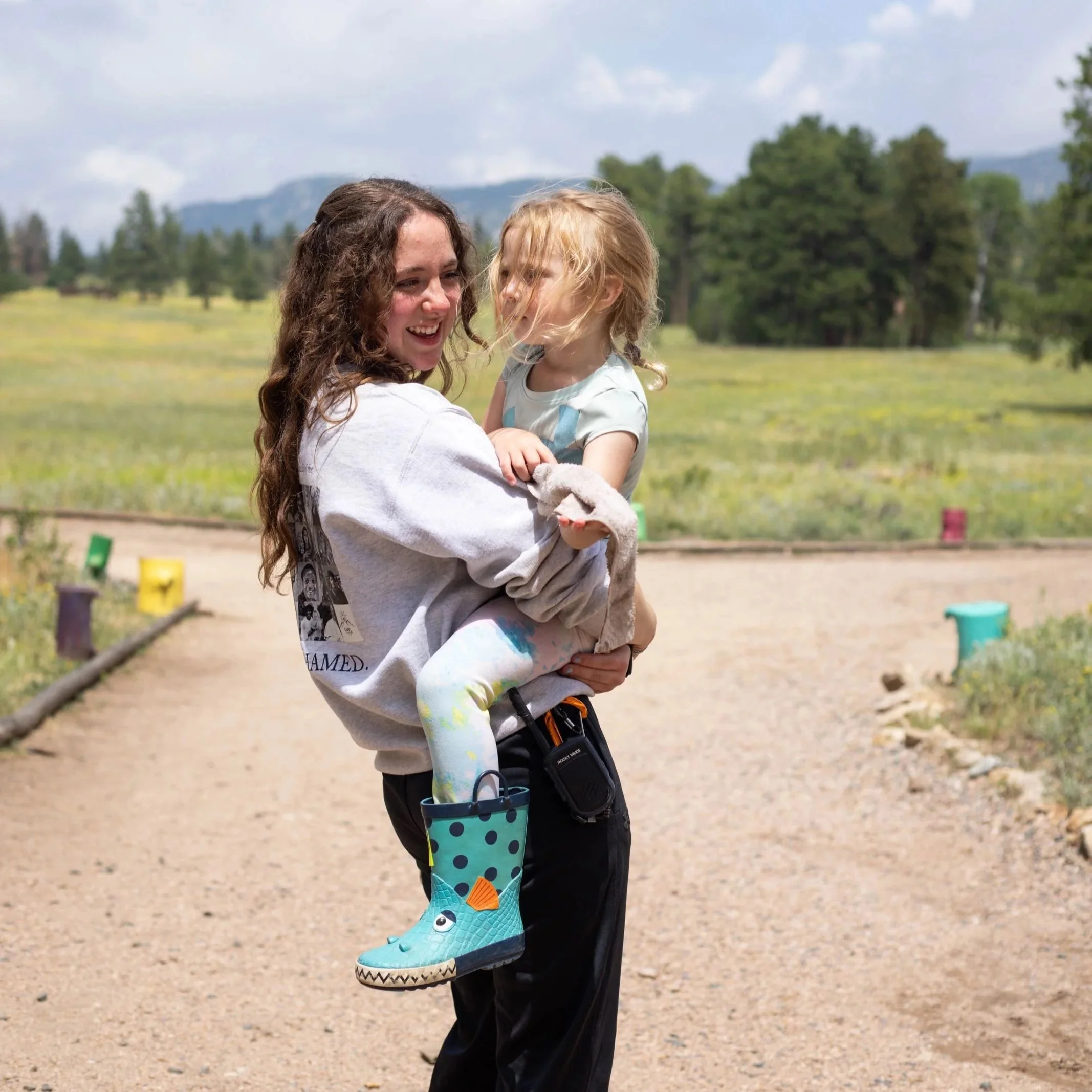 nanny at catholic summer camp holding child