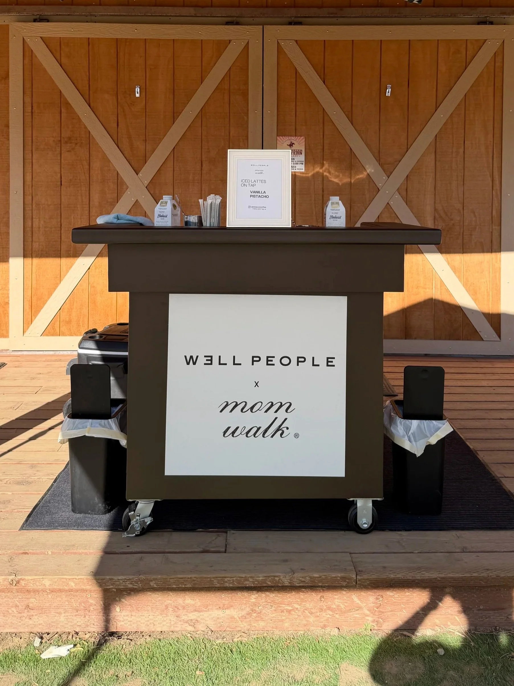 A coffee cart is shown at a brand activation event for Well People and The Mom Walk Co in Orange County, CA