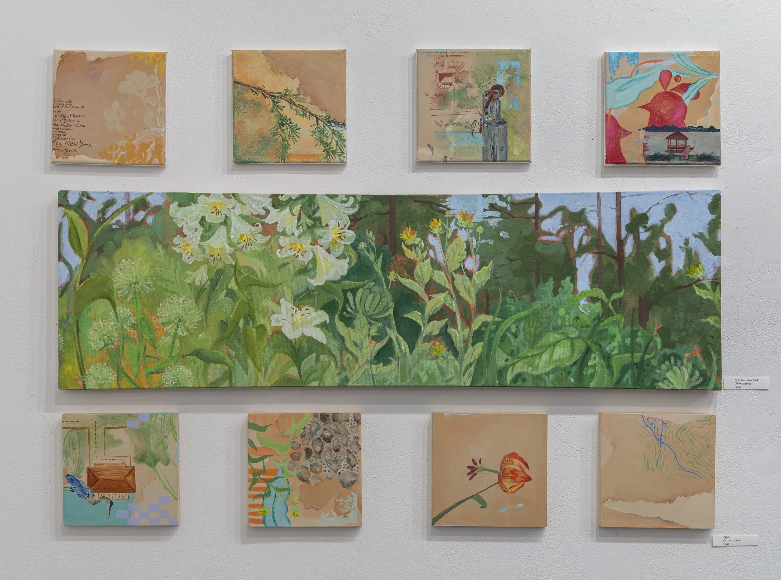 A gallery wall display of nine paintings, with a large landscape-oriented piece of greenery and white flowers in the center, surrounded by smaller abstract and nature-themed artworks.