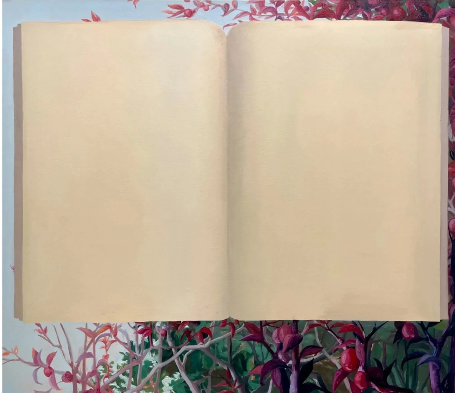 Open blank notebook on a floral tablecloth with pink and purple flowers and green leaves.