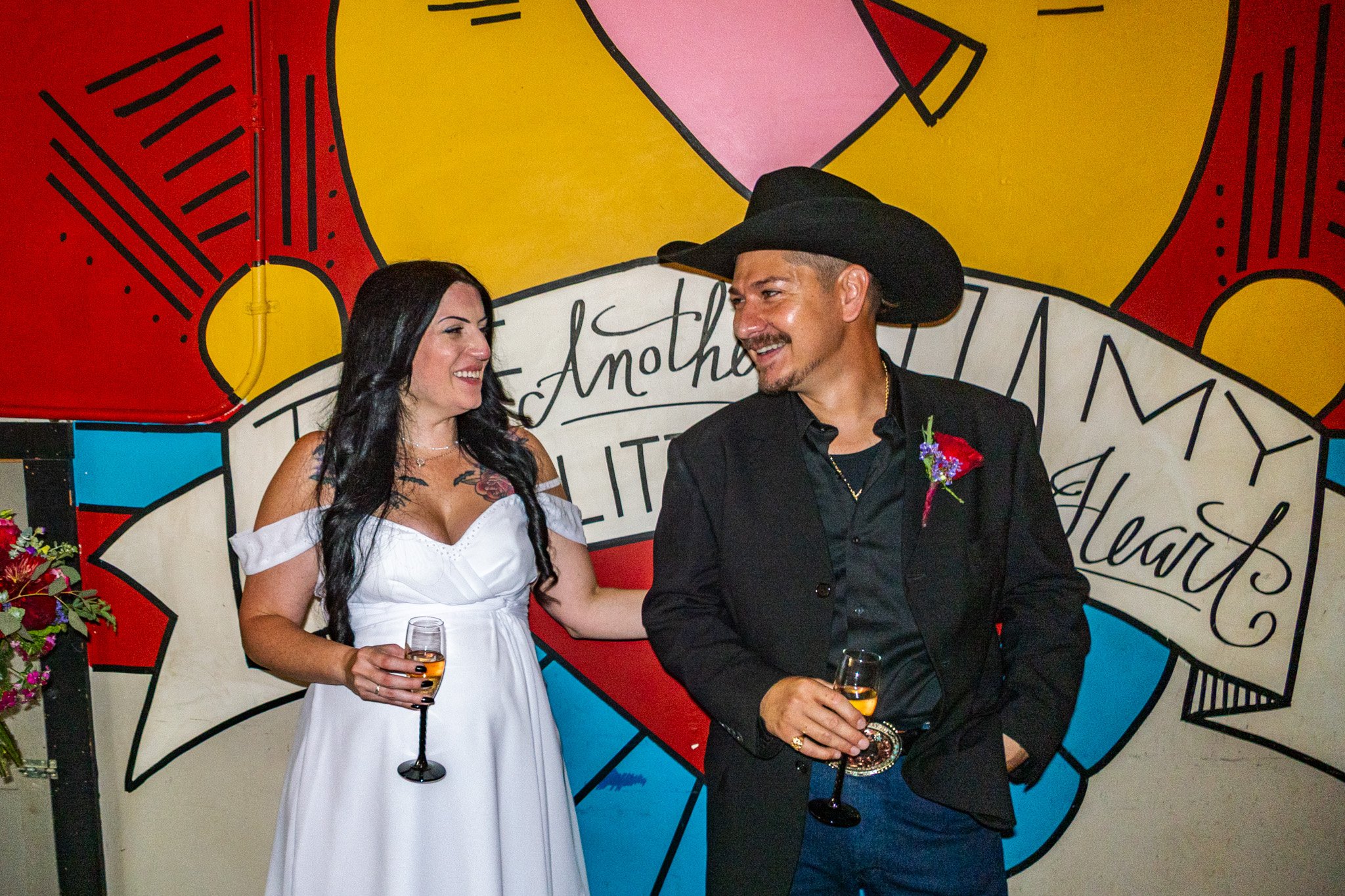 Post-Elopement Pizza Celebration – Couple Against Colorful Mural – Leica D-Lux 8