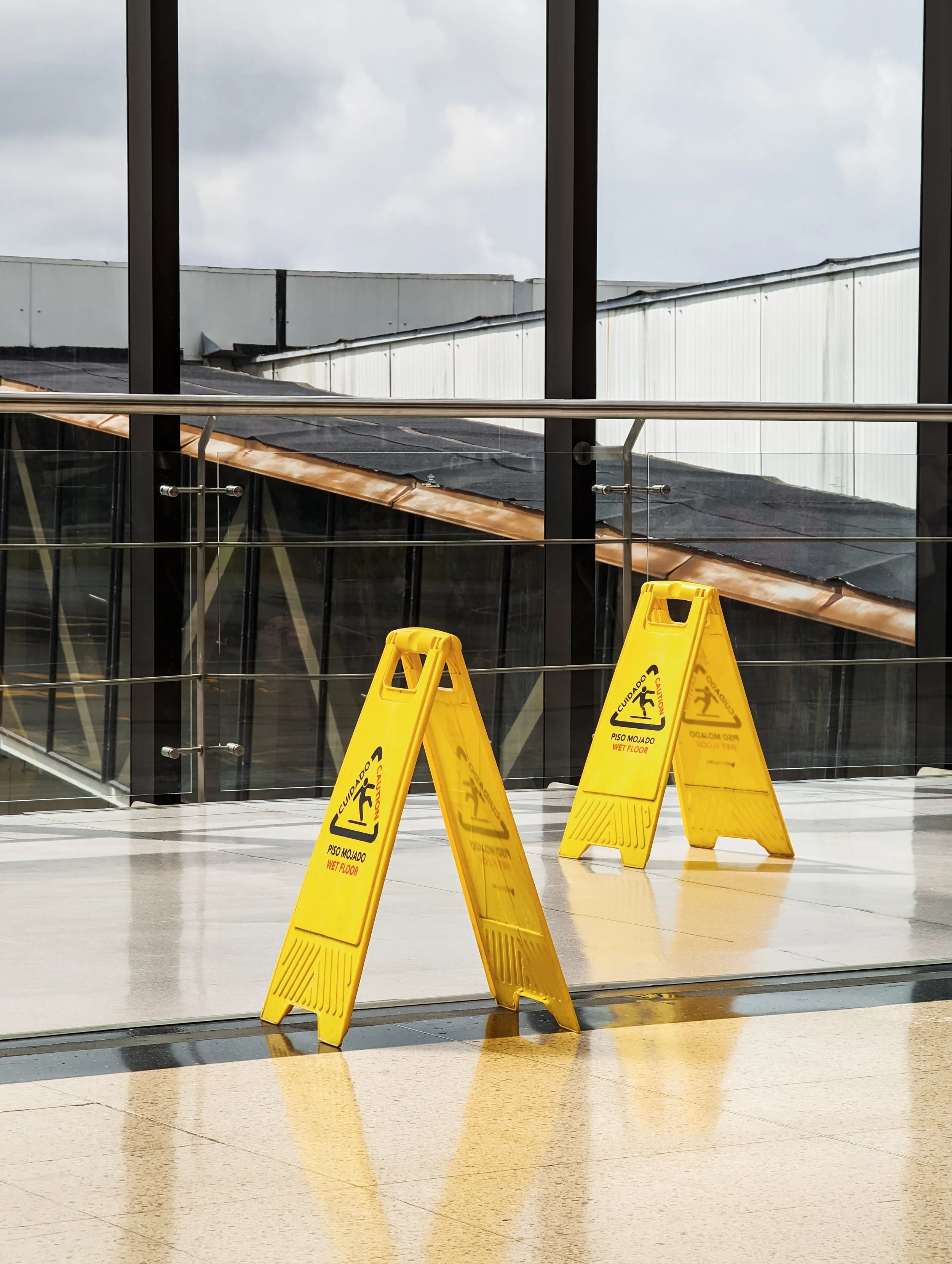 Cleaner Than Ever team member placing a caution sign to maintain workplace safety during commercial cleaning in Sydney.