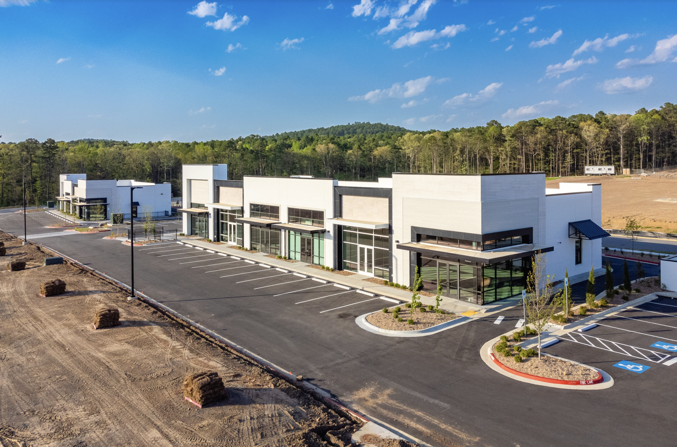 Person cleaning carpet with Bissell BigGreen carpet cleaner in an office conference room.
