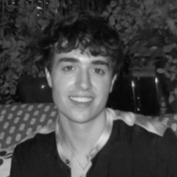 A black and white graphic design featuring two mirrored female profiles with flowing hair, surrounded by decorative elements, including a ribbon with Latin text and a crest with the initials 'NF' at the top.