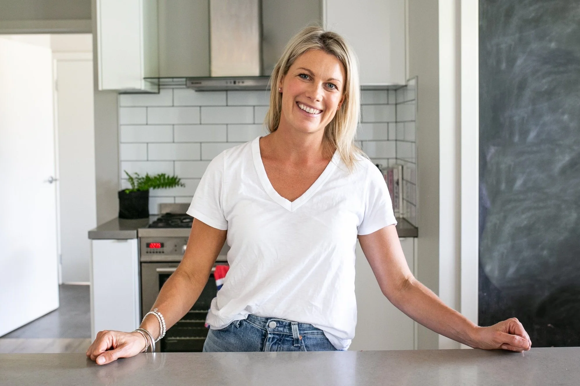 GLP-1 dietitian standing in kitchen smiling