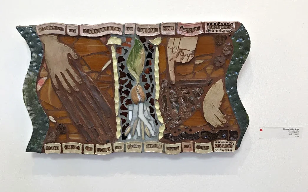 Mixed media artwork with hands, a plant, and soil elements, with text referencing the importance of seeds and education.