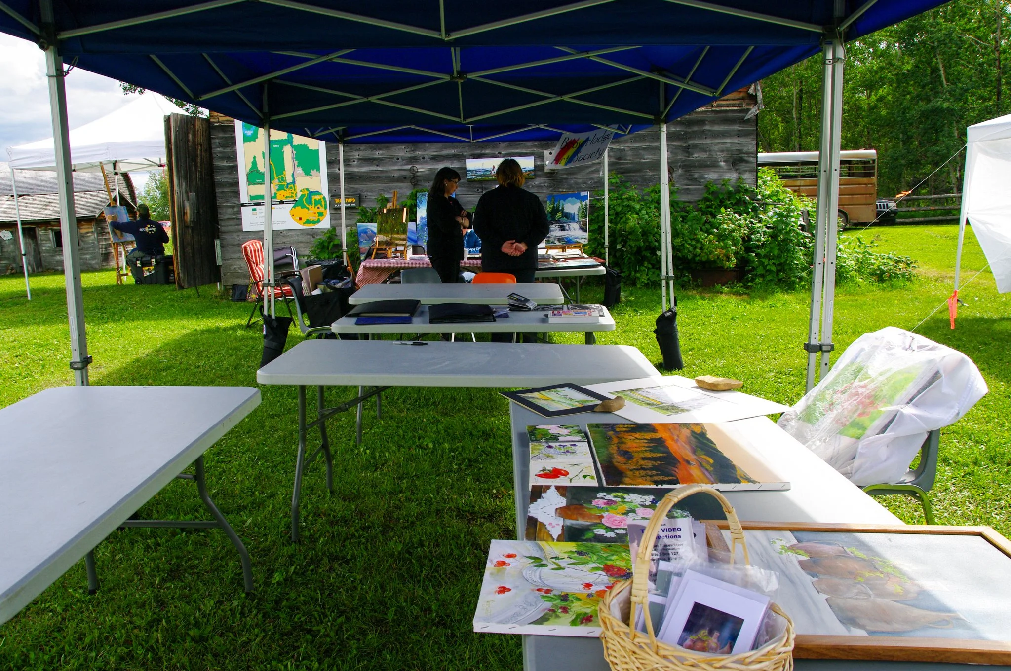 Tables at a festival with displayed art work