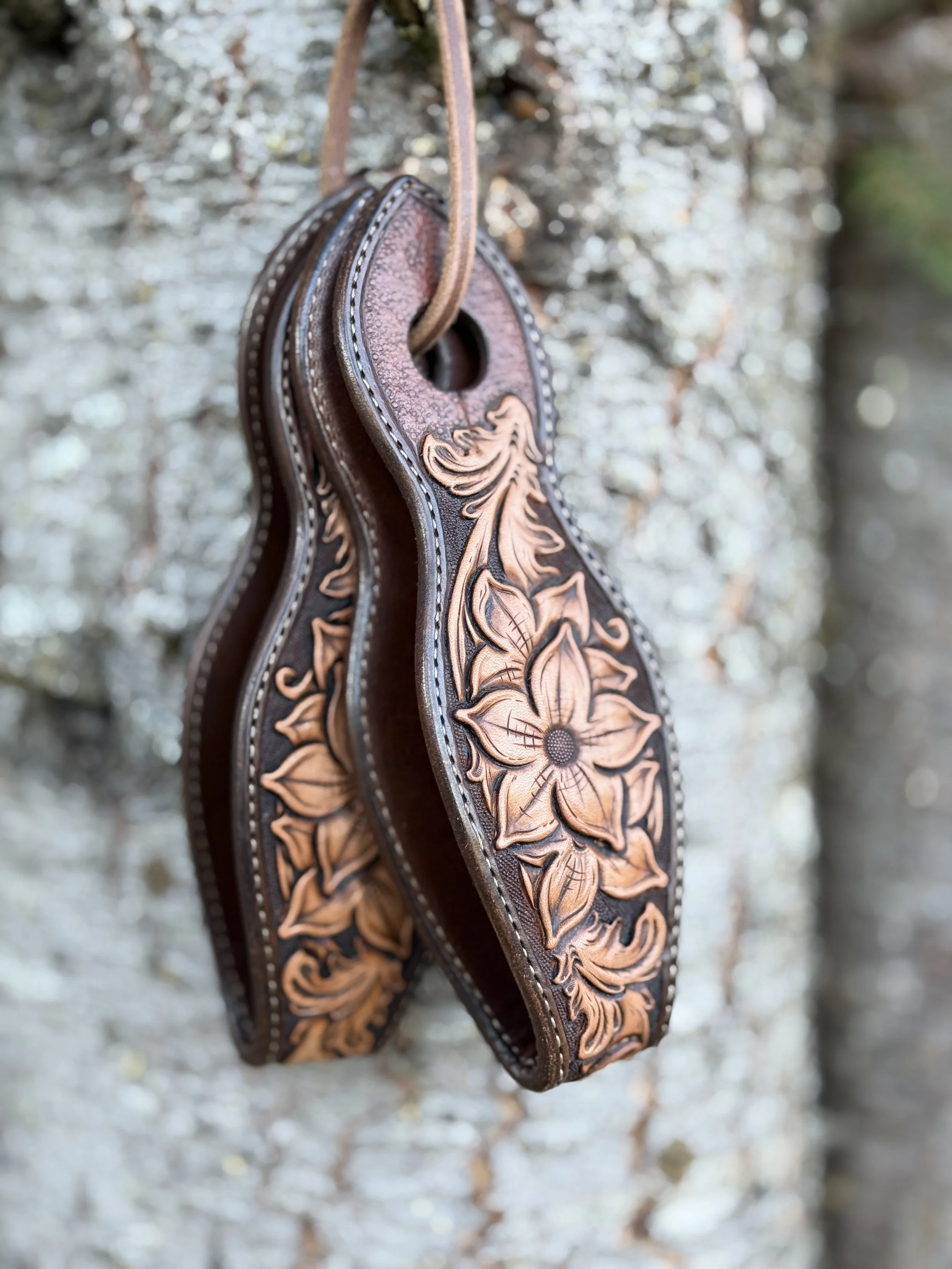 Custom floral tooled slobber straps made with Hermann Oak Leather