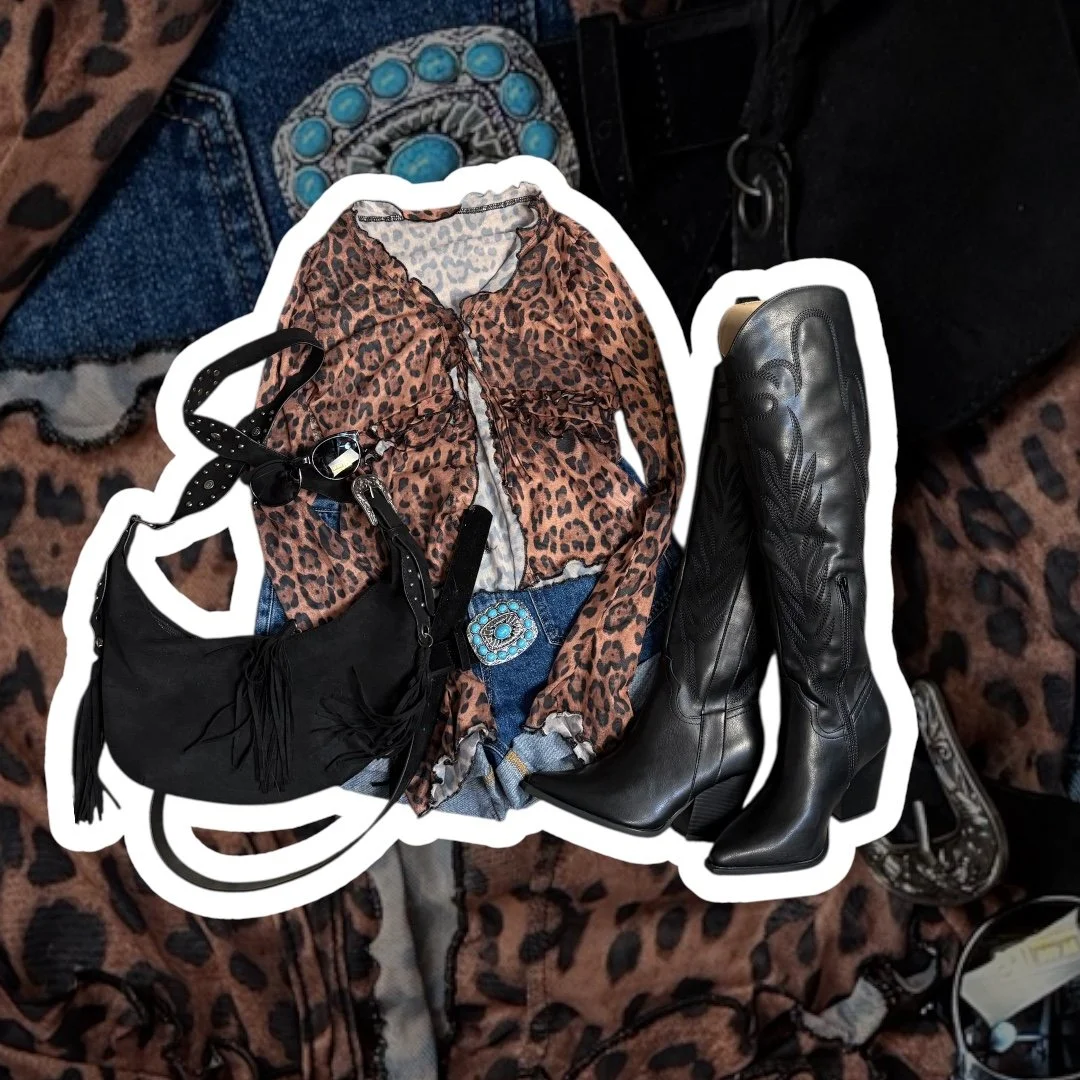 Leopard print shirt, blue jeans with a turquoise belt, black fringe purse, black saddle cowboy boots.