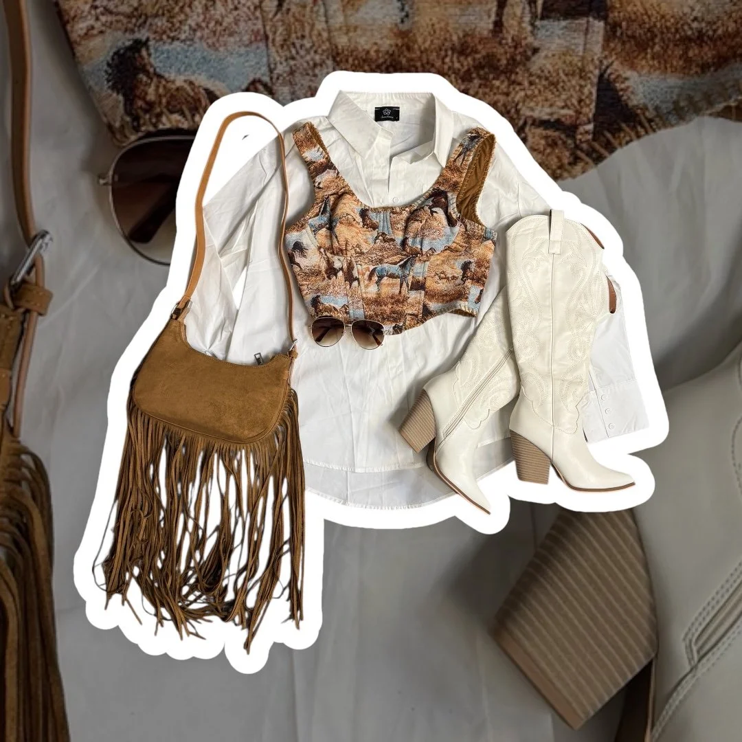 Outfit including white shirt, printed vest, cream high-heeled boots, brown fringed shoulder bag, and sunglasses, arranged on a white fabric surface with a tapestry and a chair nearby.