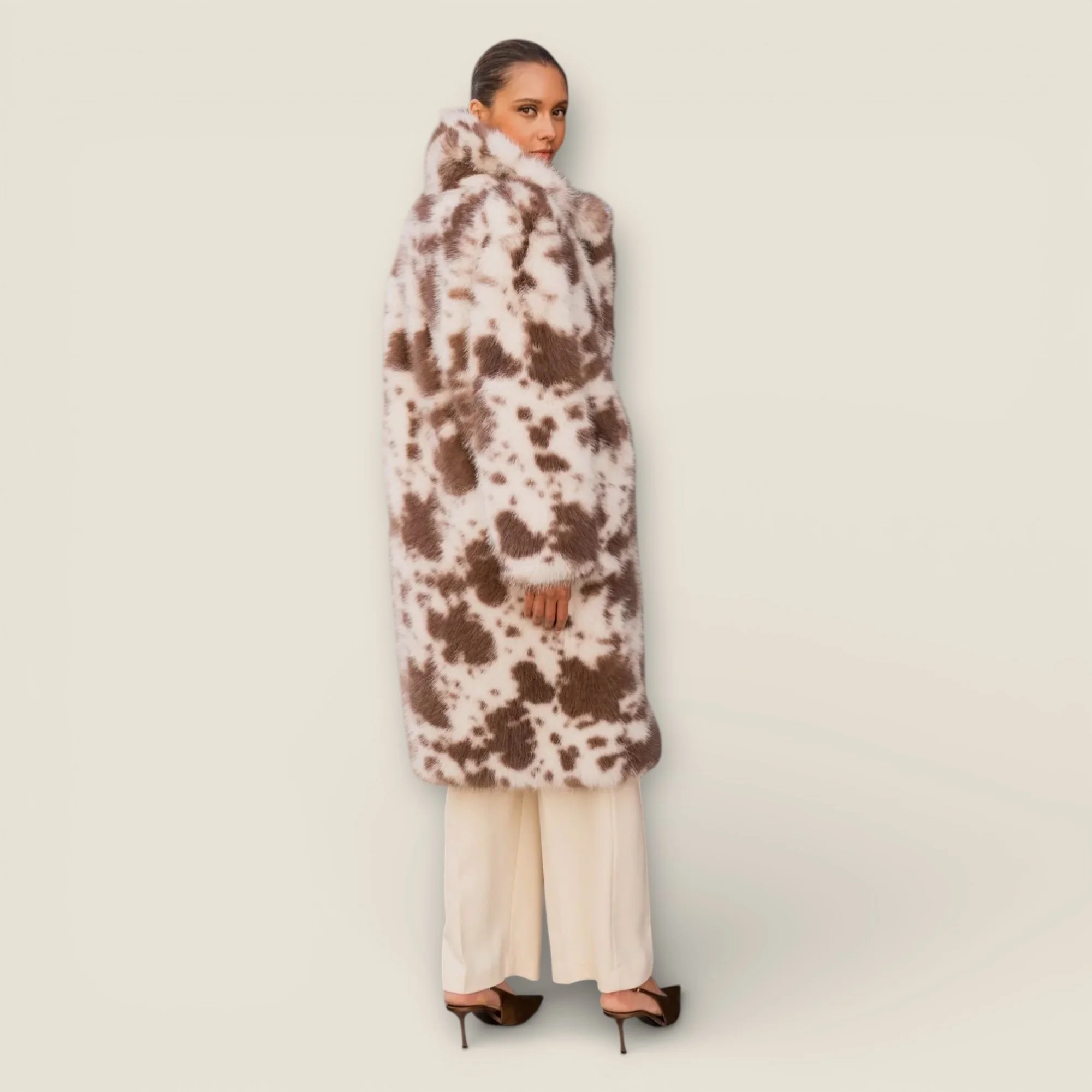 Long coat in faux cow print fur