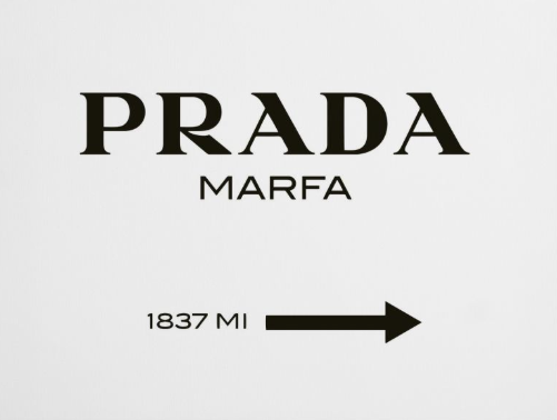 Prada Marfa art installation with an arrow and distance marker pointing right, 1837 miles.