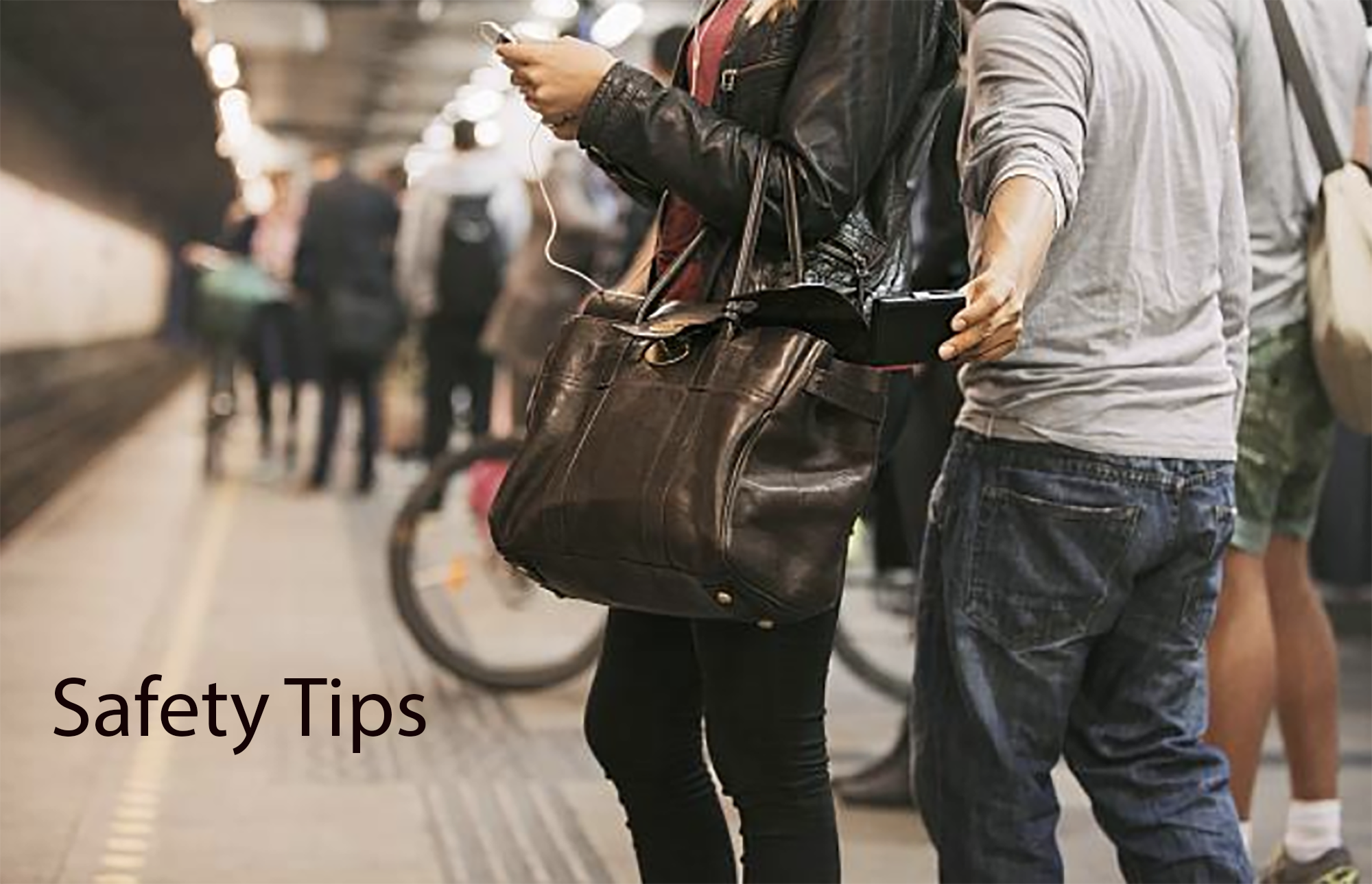 People waiting at a subway station, with one person looking at a smartphone and wearing earphones, carrying a large leather bag, and another person holding a ticket or phone. Text overlay says 'Safety Tips.'