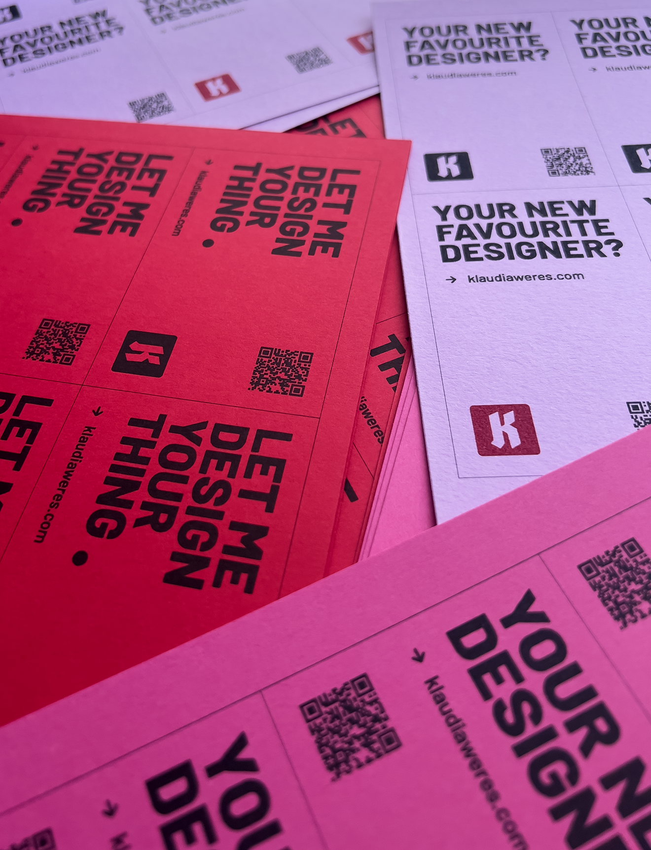 A collection of colorful business cards in pink, purple, and red.