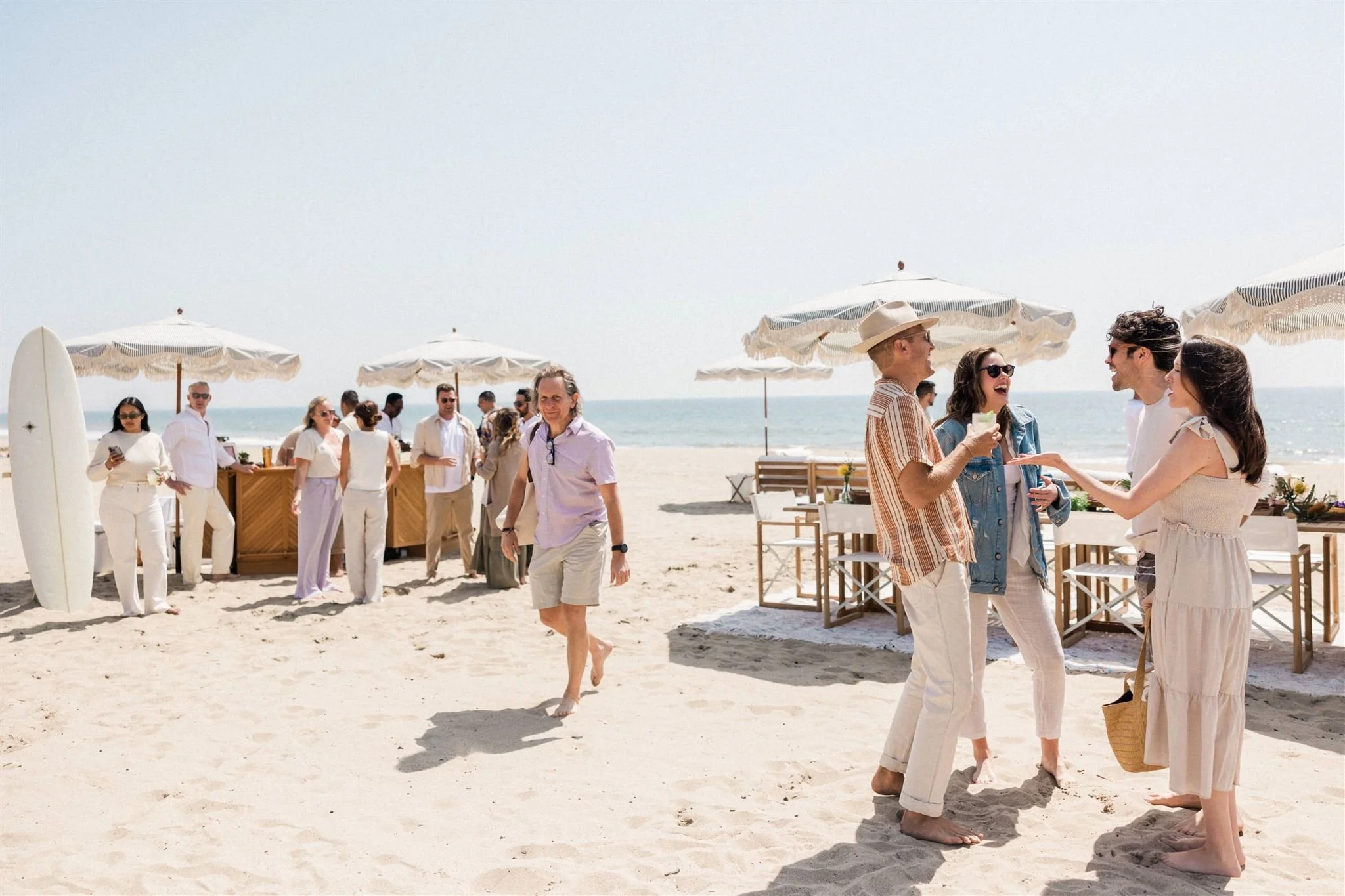 Engagement party on the sand with bar and dining table