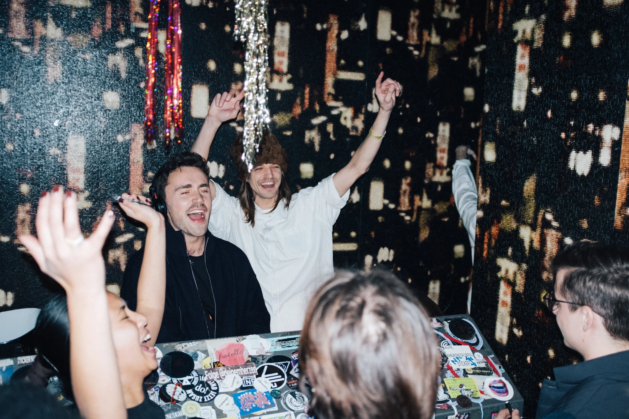 Group of friends dancing and enjoying music at a party.