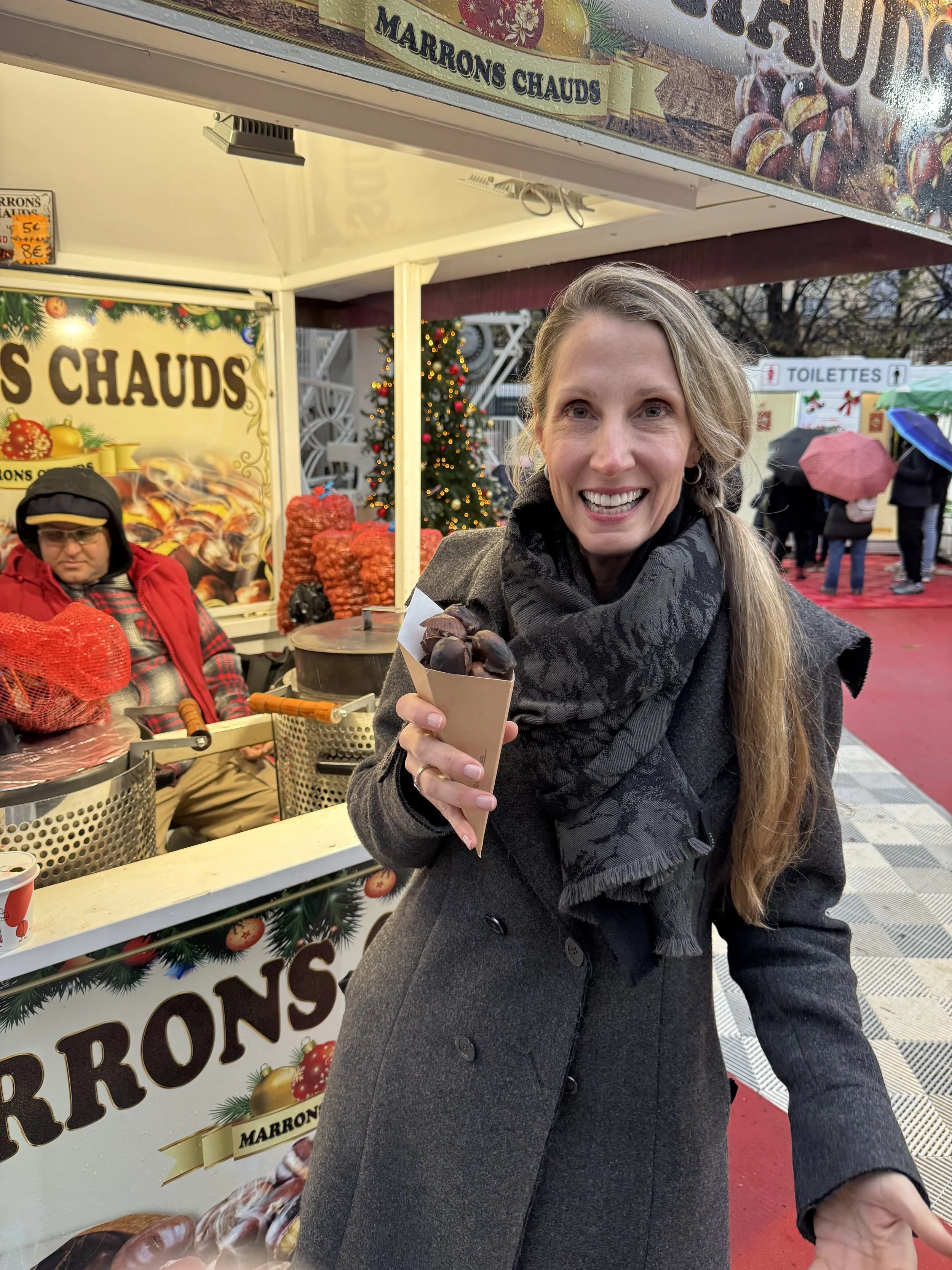 Alicia at winter market in Paris, eating roasted chestnuts