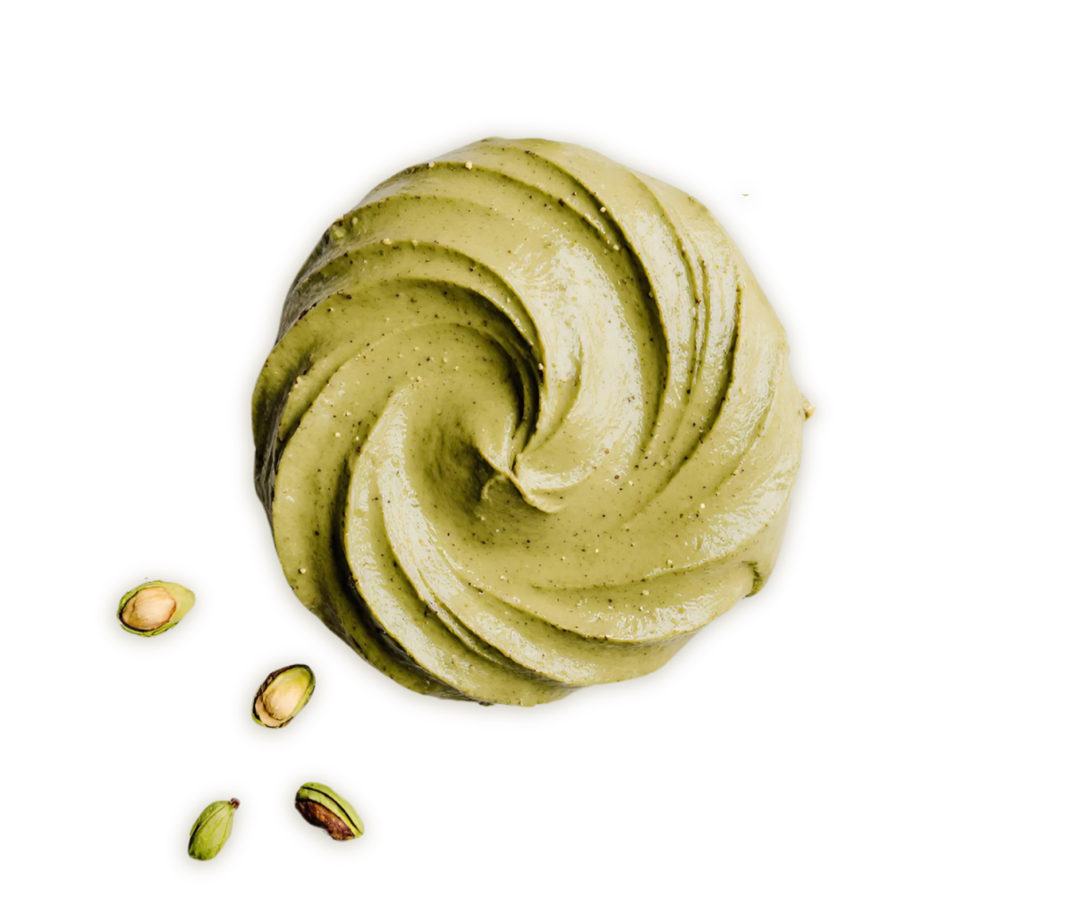 A swirl of pistachio-flavored with pistachio nuts scattered beside it.