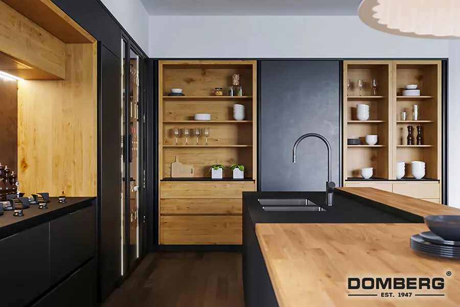 Modern kitchen with black cabinets, wooden open shelves, and a black island with a sink and faucet.