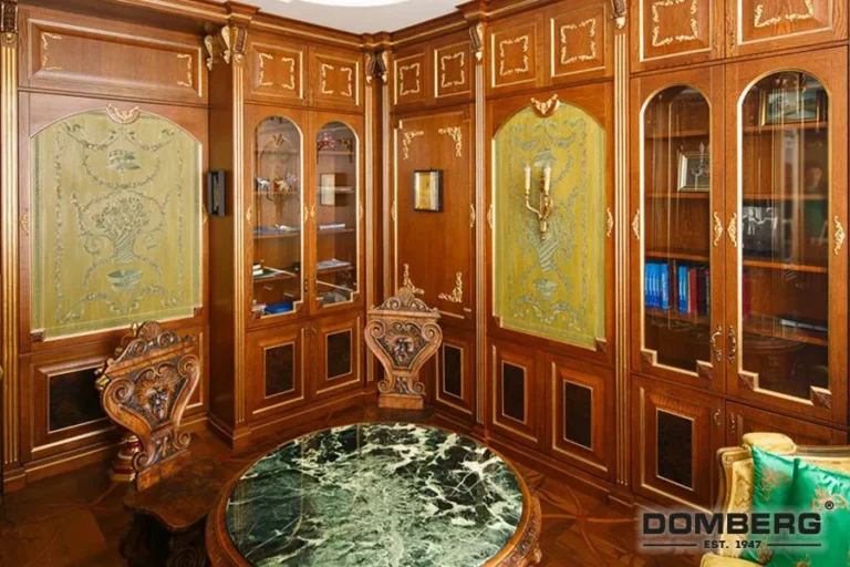 A luxurious room with ornate wooden paneling, glass-fronted bookshelves, and a marble-topped table in the center.