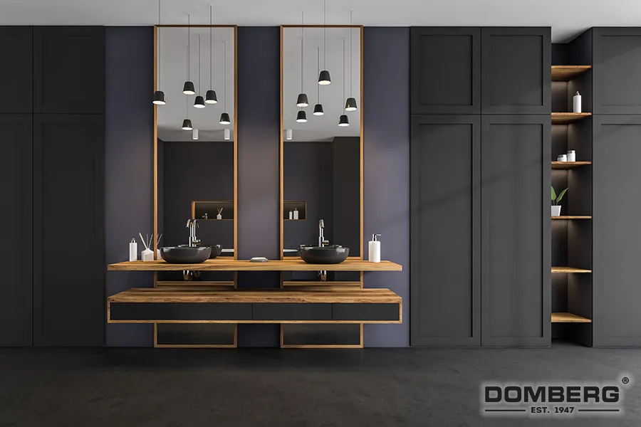 Modern bathroom with dark gray cabinetry, wooden accents, two black vessel sinks, large mirrors, pendant lighting, and open shelves with decor, by Domberg.