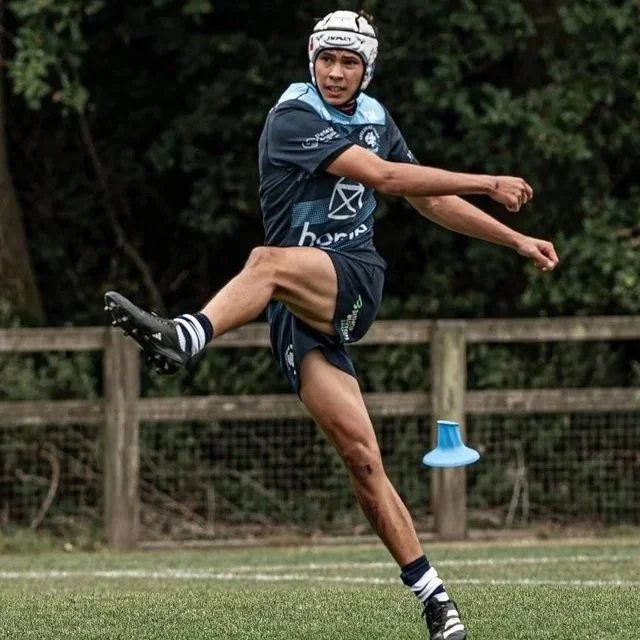 Caylen Umaga action shot just after kicking ball