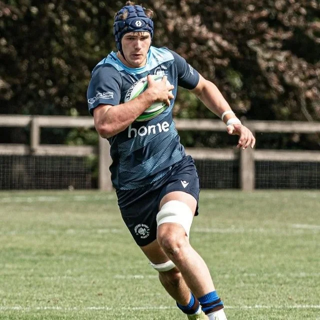 Alex Fusco action shot running with ball