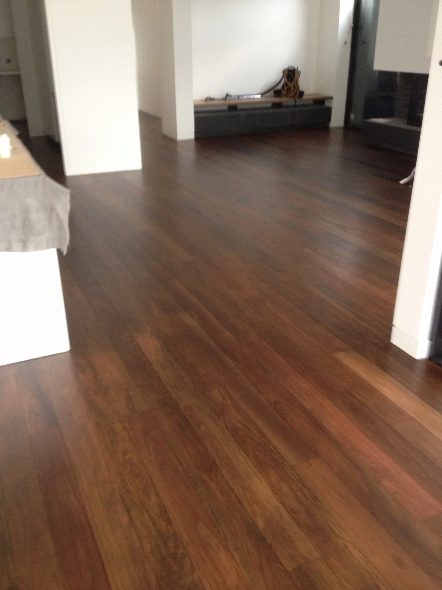 Wooden flooring in a modern interior space with minimal furniture and decor.