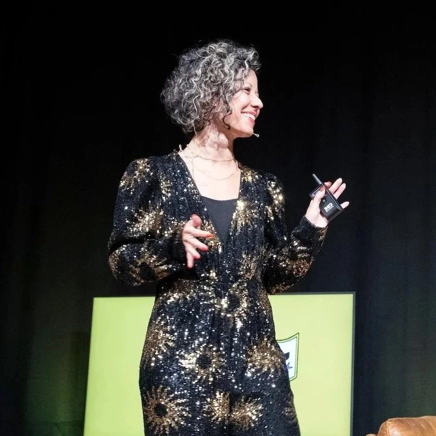 Rafaela Buena speaking on stage as an AI keynote speaker in Amsterdam