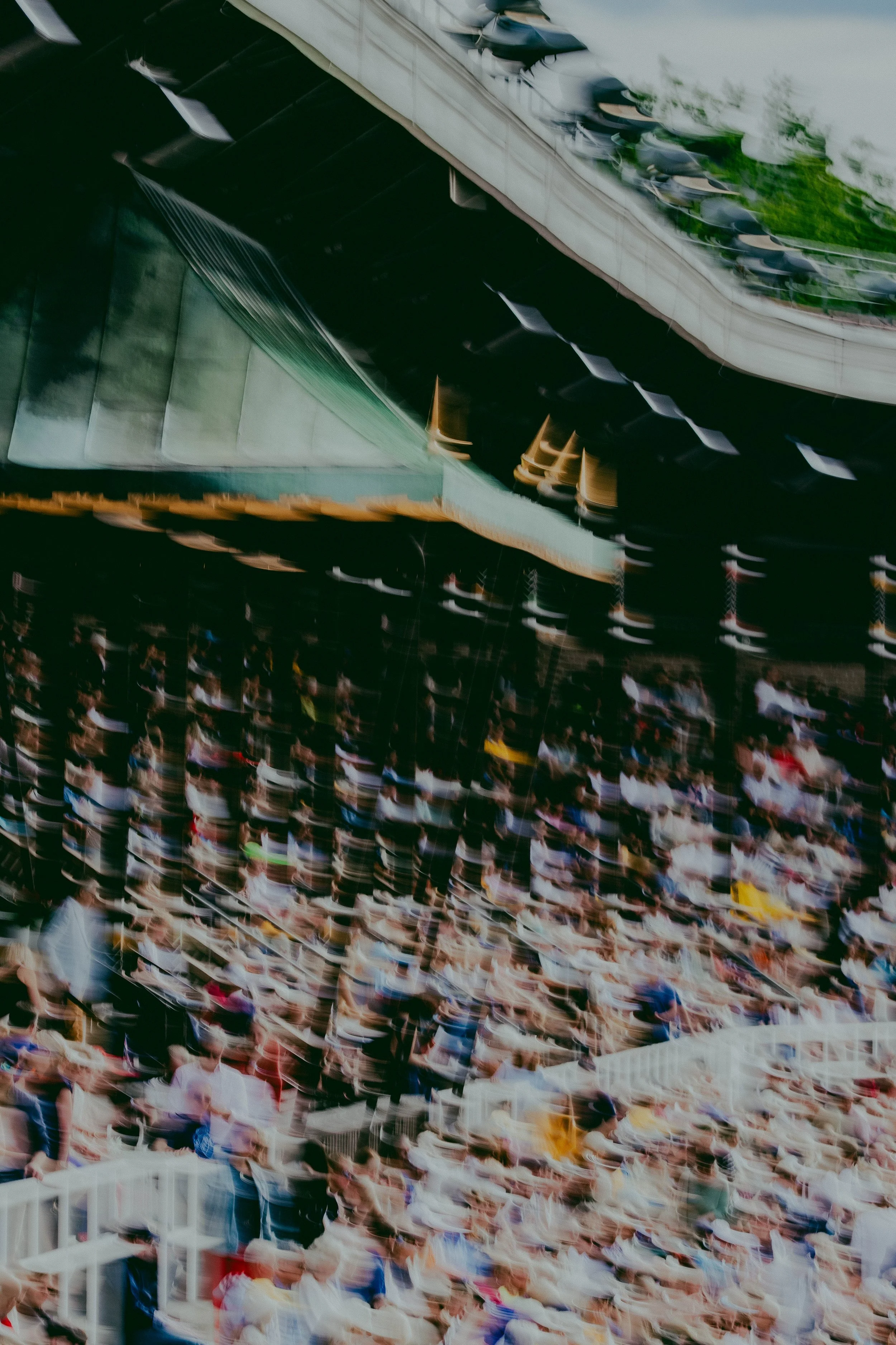 A large crowd of people sitting in an indoor stadium or arena, watching an event.
