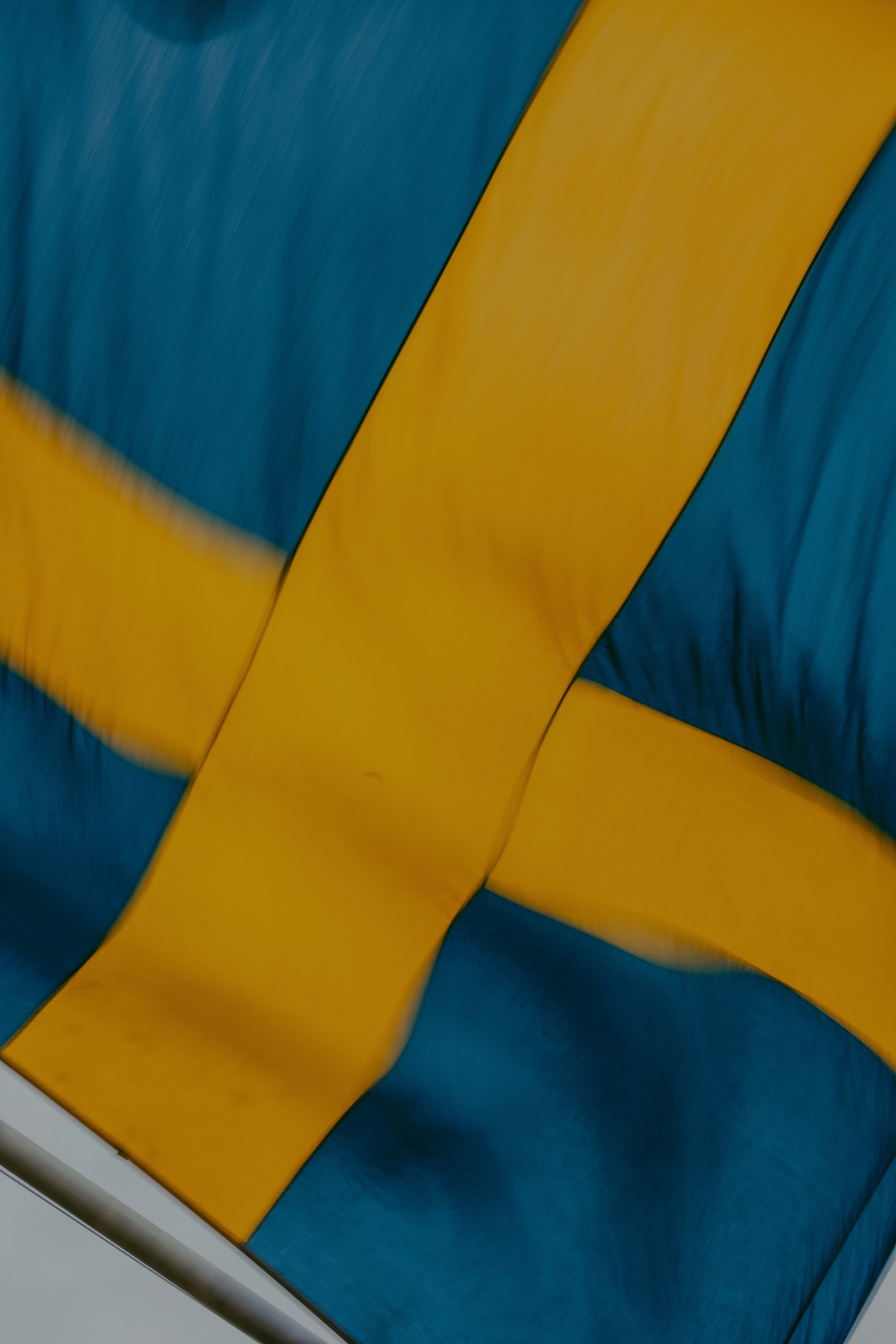 Close-up of a colorful abstract design with yellow and blue curved shapes.