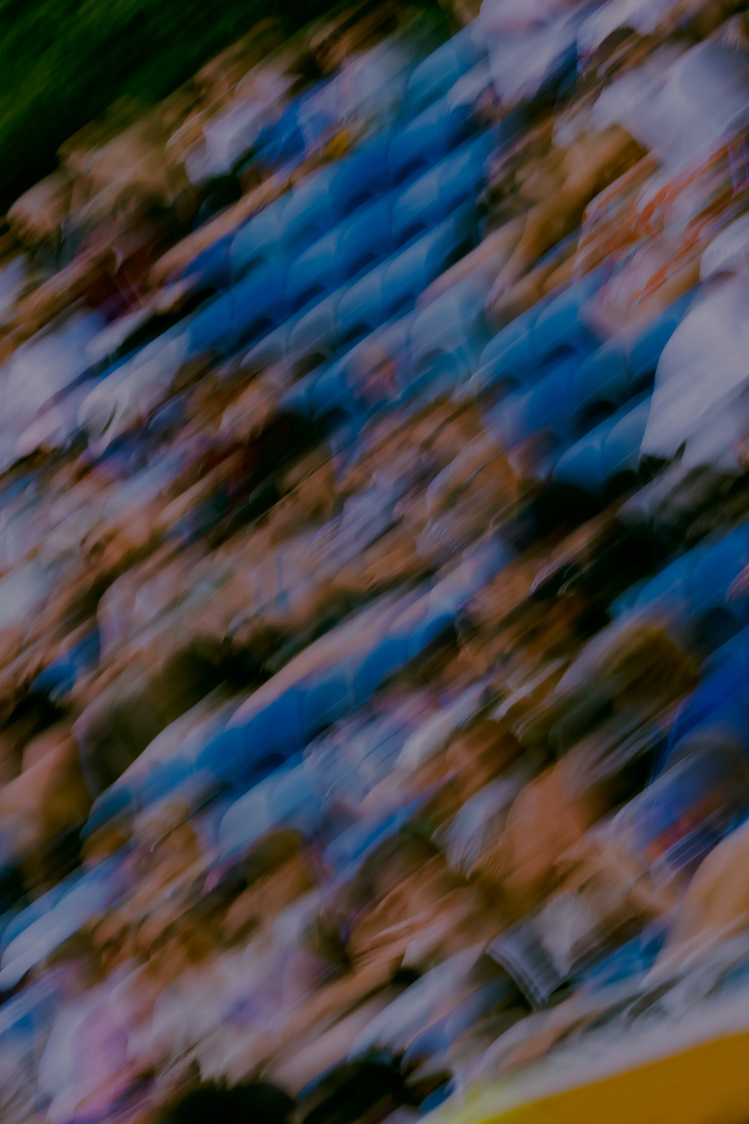 A blurred image with abstract streaks of colors including blue, brown, white, and green.