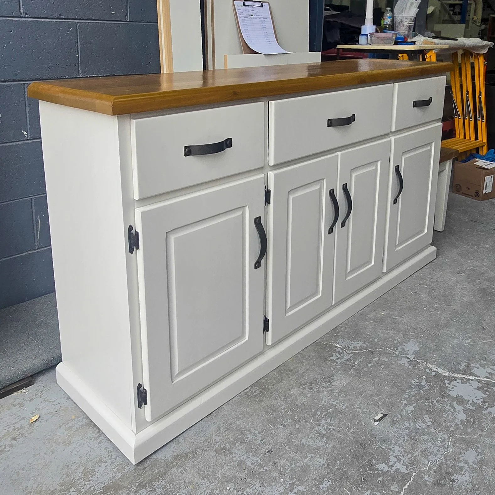 Detailed polyurethane spray painted finish and a lacquer stained top on a refurbished buffet unit. Crisp, fresh finish. 