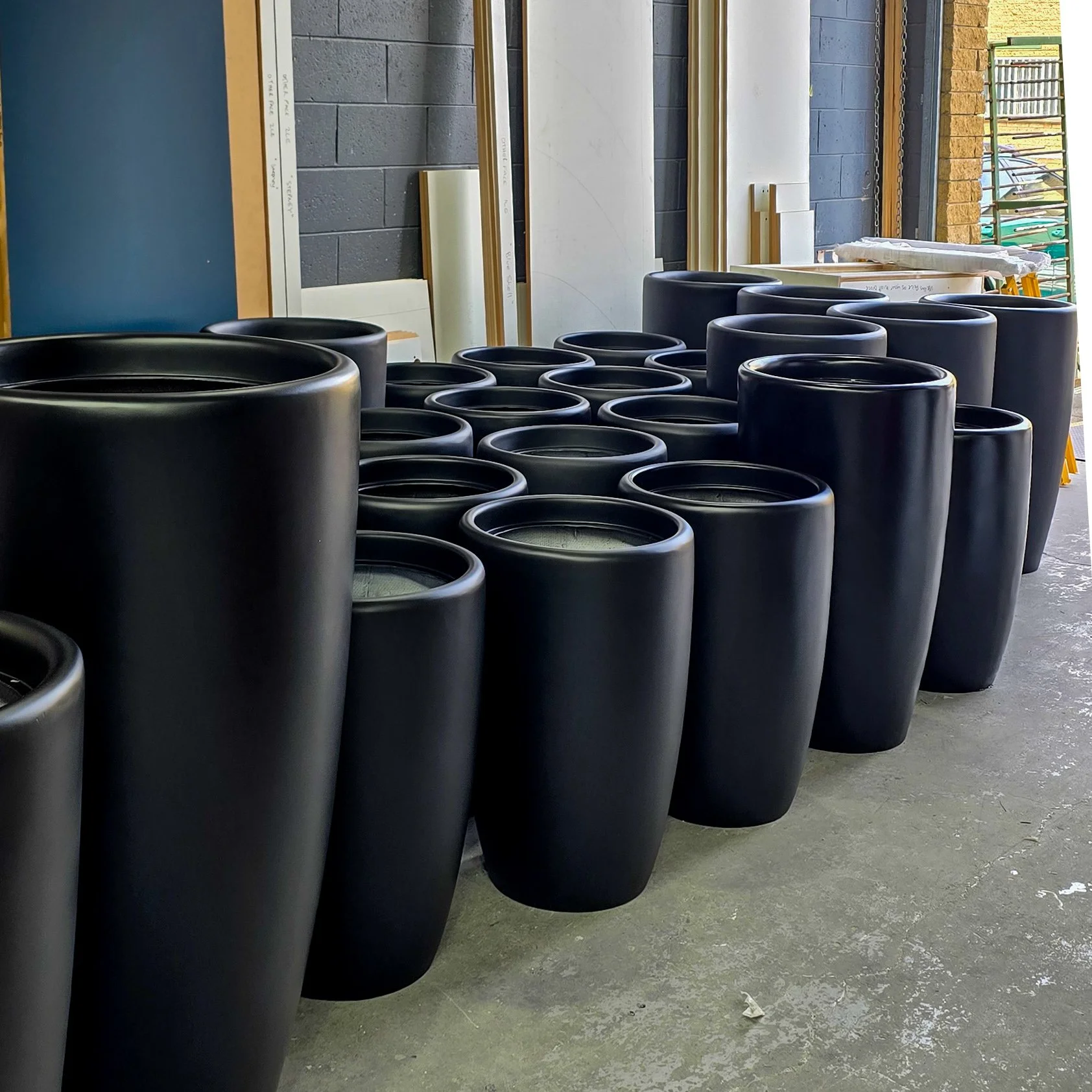 dark polyurethane finish on a set of different sized pots. 