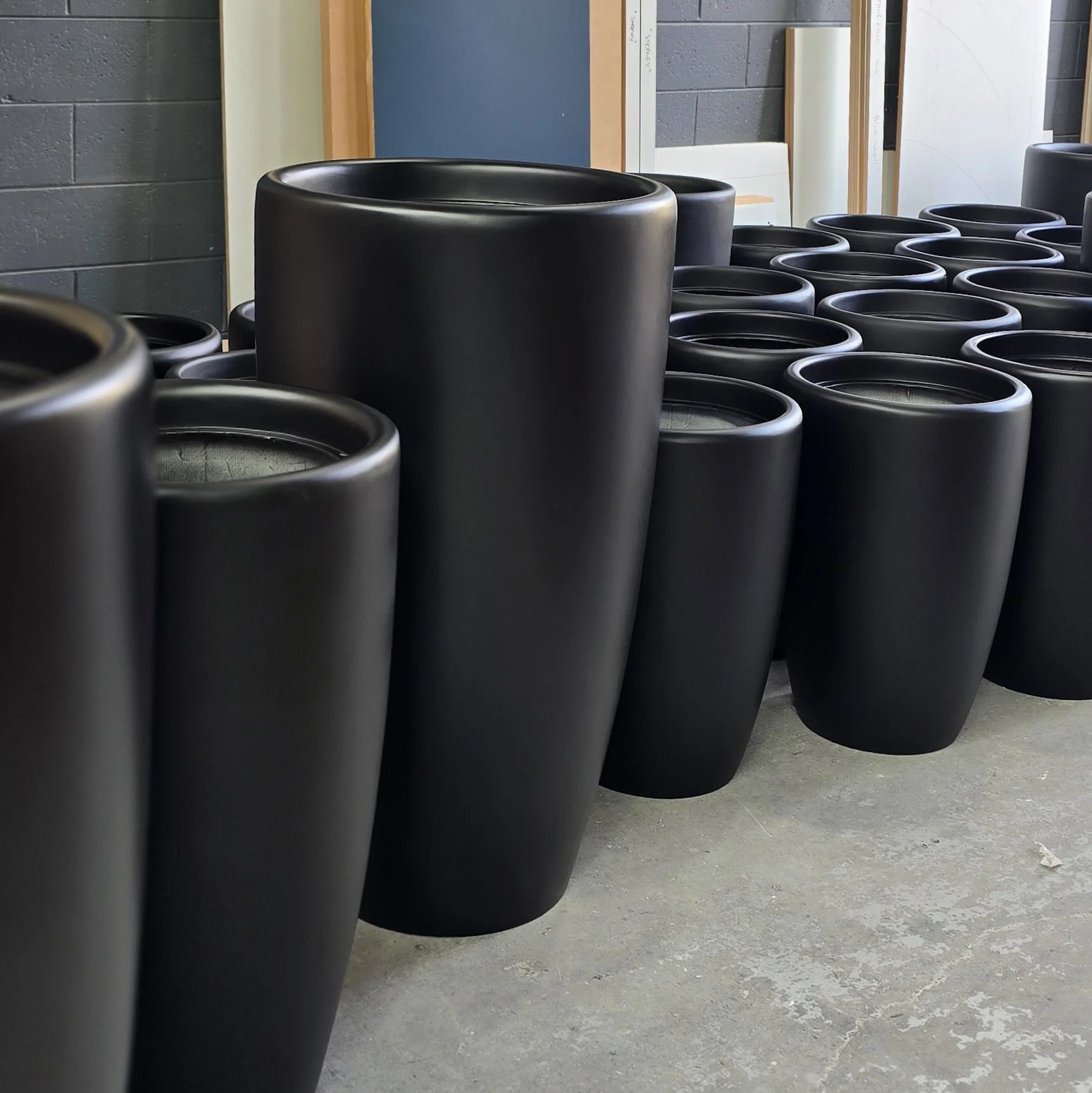 dark polyurethane finish on a set of different sized pots. 