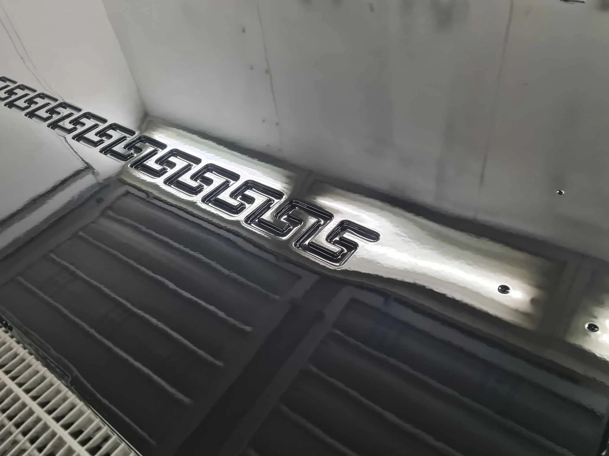 Close-up of a metallic Chevrolet logo on a vehicle's interior panel.