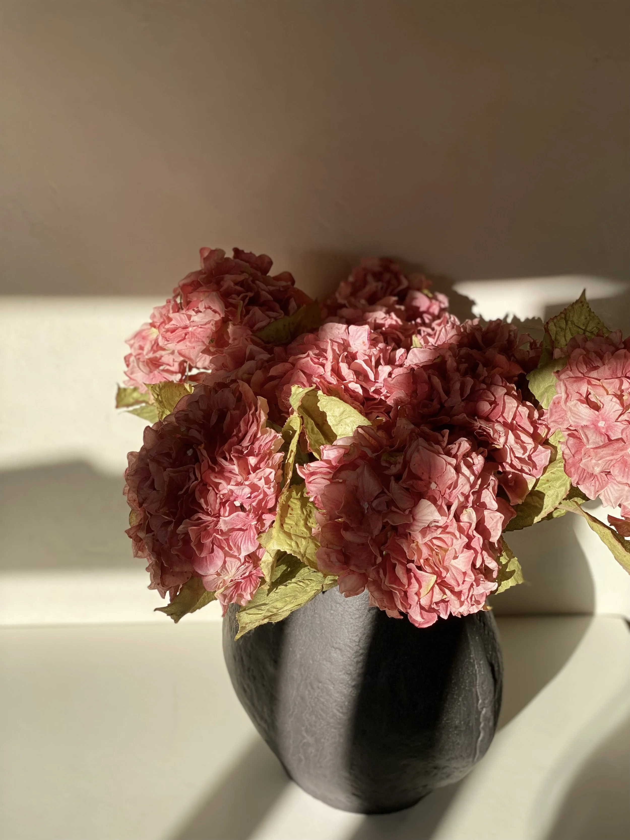 pink faux Hydrangea flowers in a vase